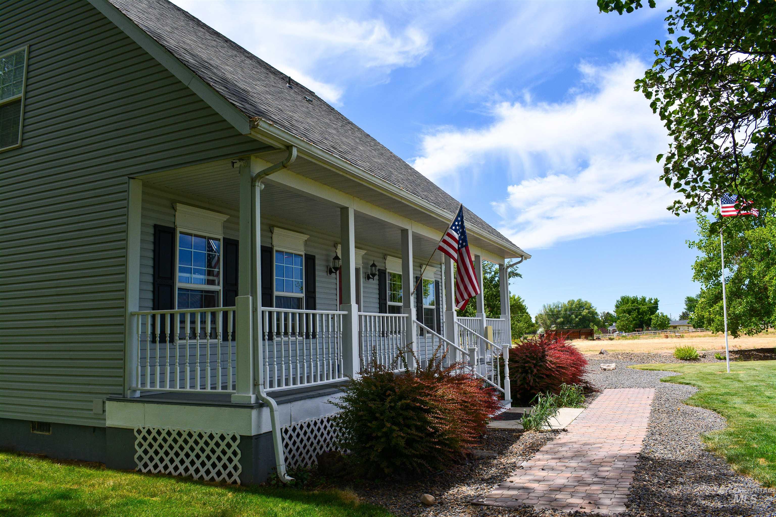 View of side of property featuring a porch, roof with shingles, and crawl space