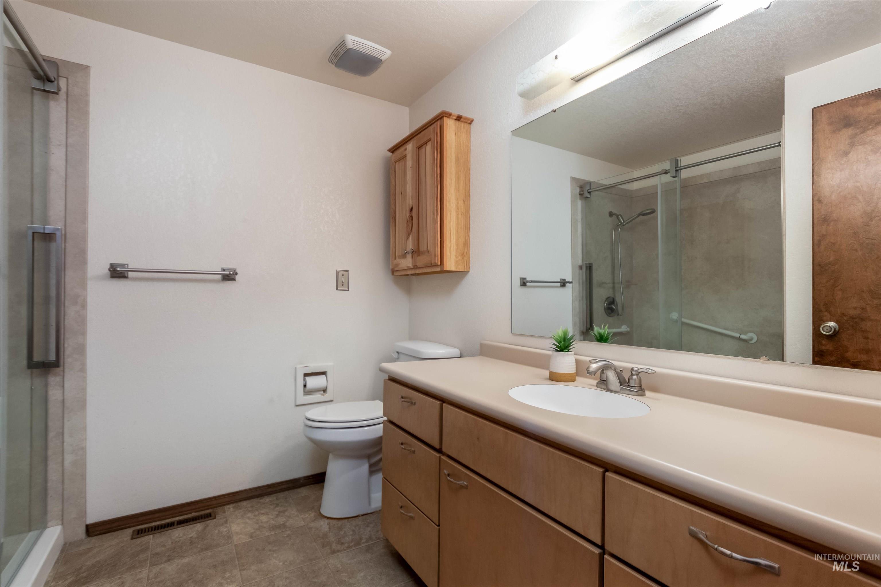Bathroom with vanity and a shower stall