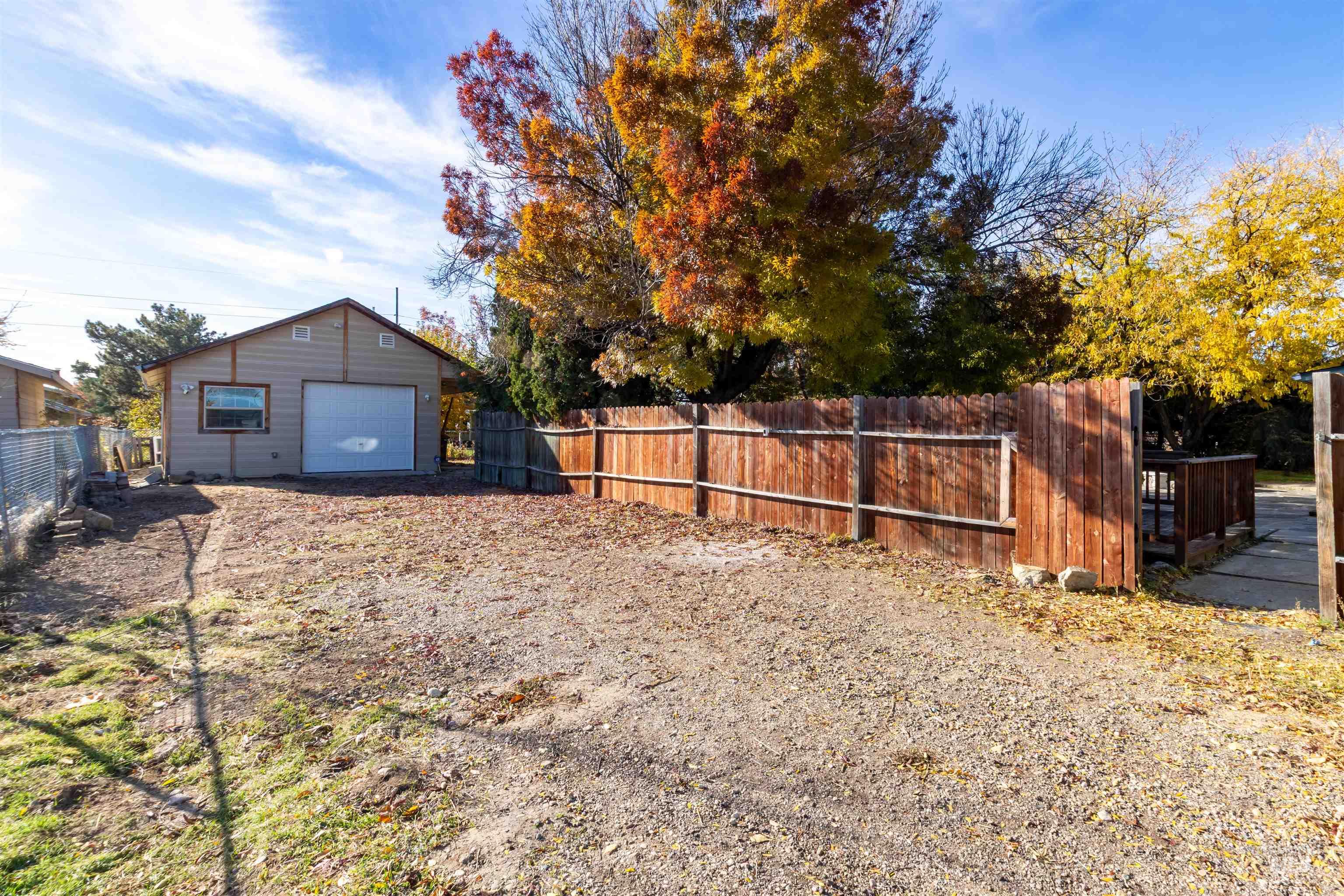 View of yard with an outdoor structure and a garage
