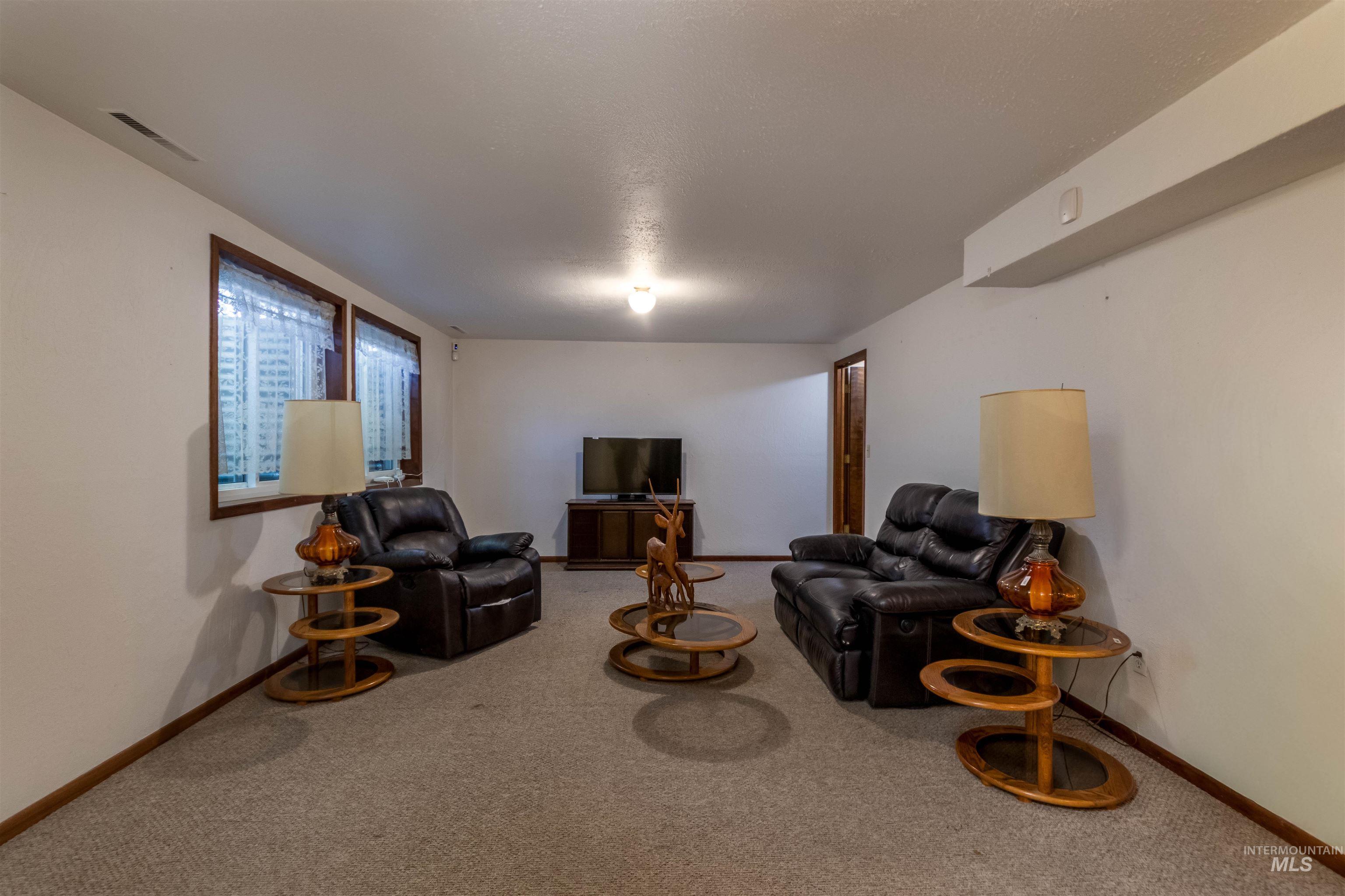 Living area with carpet floors and baseboards