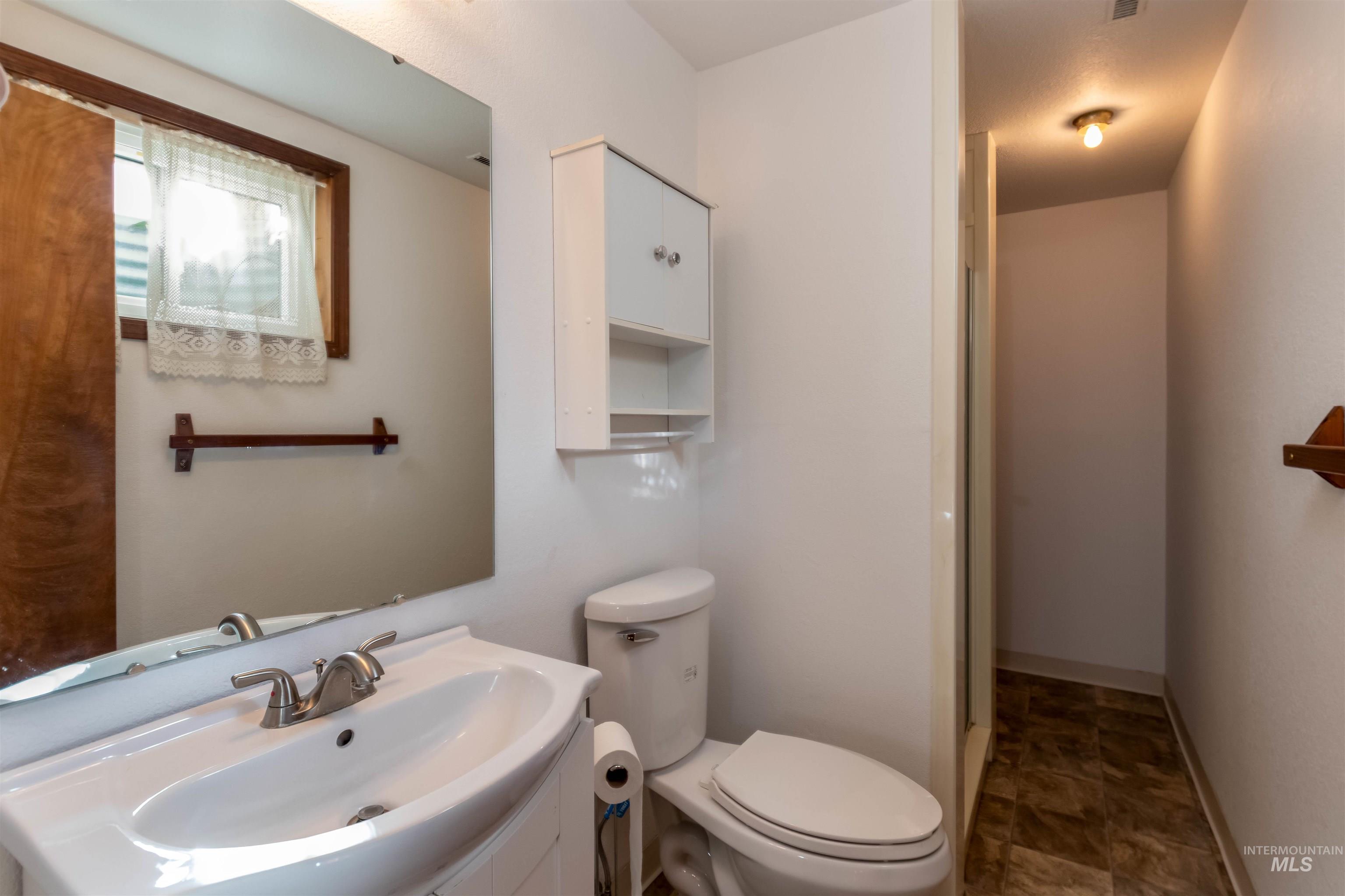 Bathroom featuring vanity and toilet