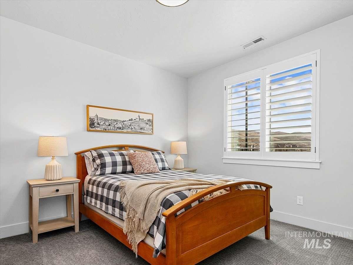 Bedroom with baseboards and carpet flooring