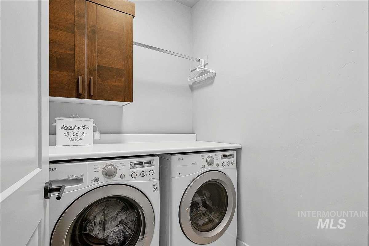 Laundry area featuring cabinet space and washing machine and clothes dryer