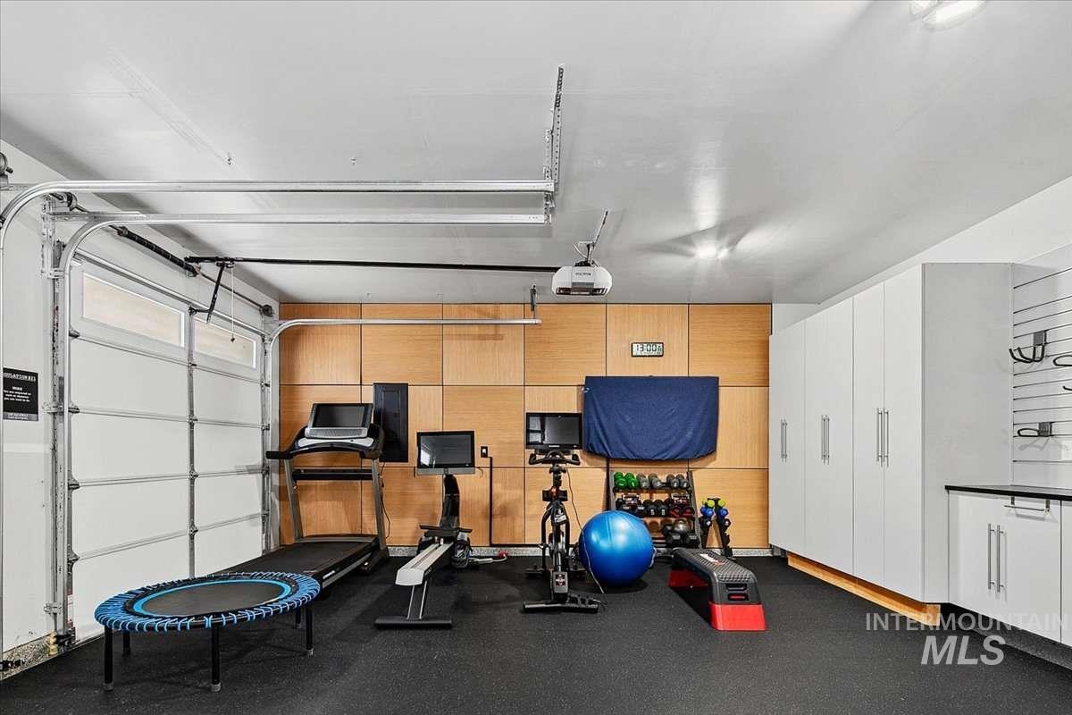 Exercise area featuring dark flooring and a garage