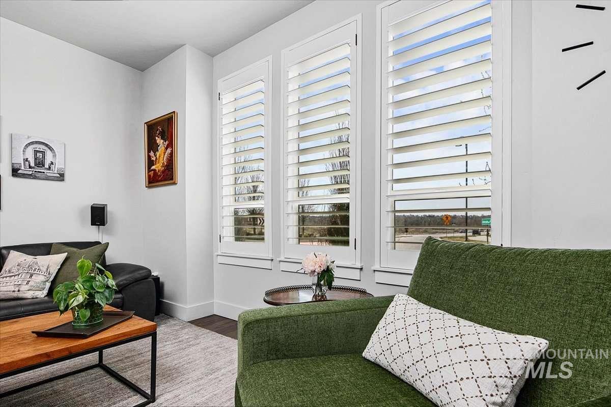 Sitting room with wood finished floors and baseboards