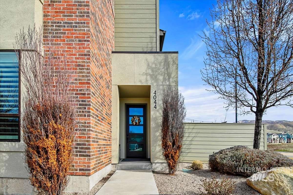 Doorway to property with brick siding