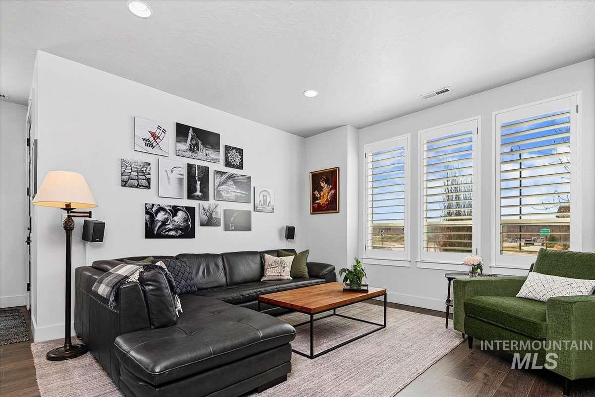Living area with wood finished floors and recessed lighting