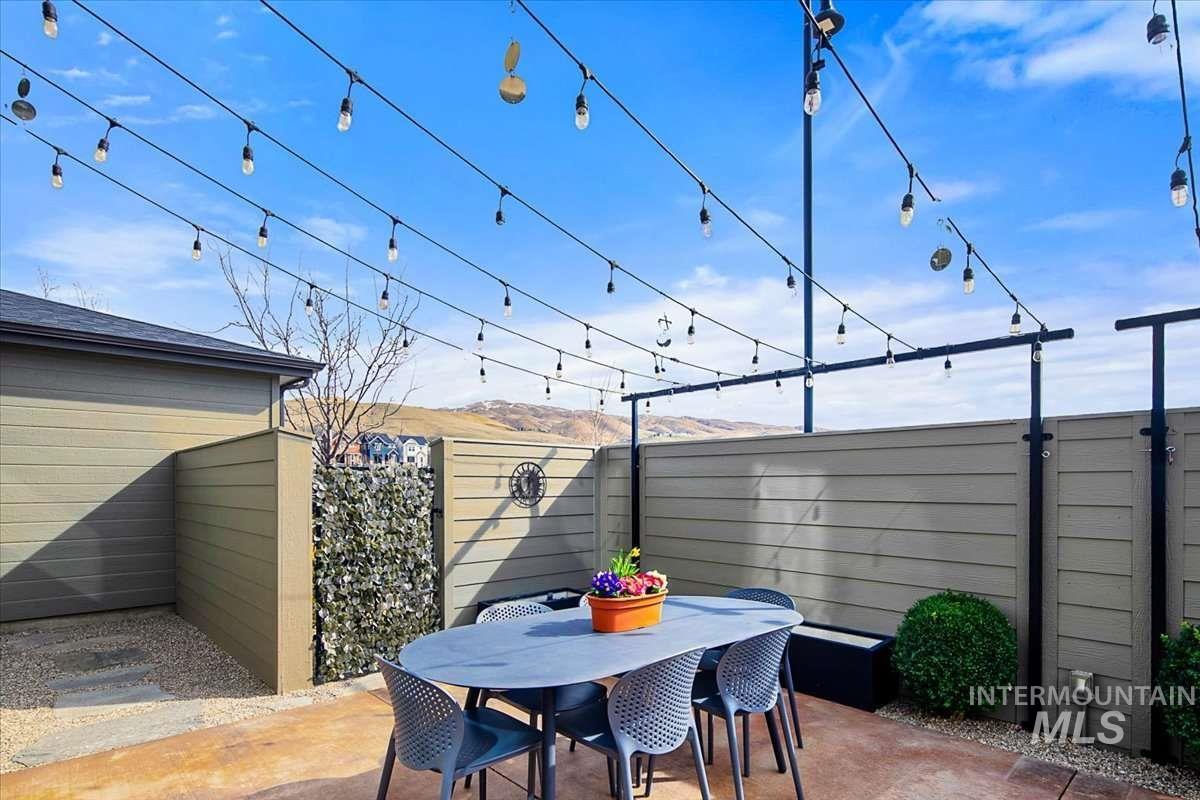 Fenced backyard with outdoor dining space and a patio area