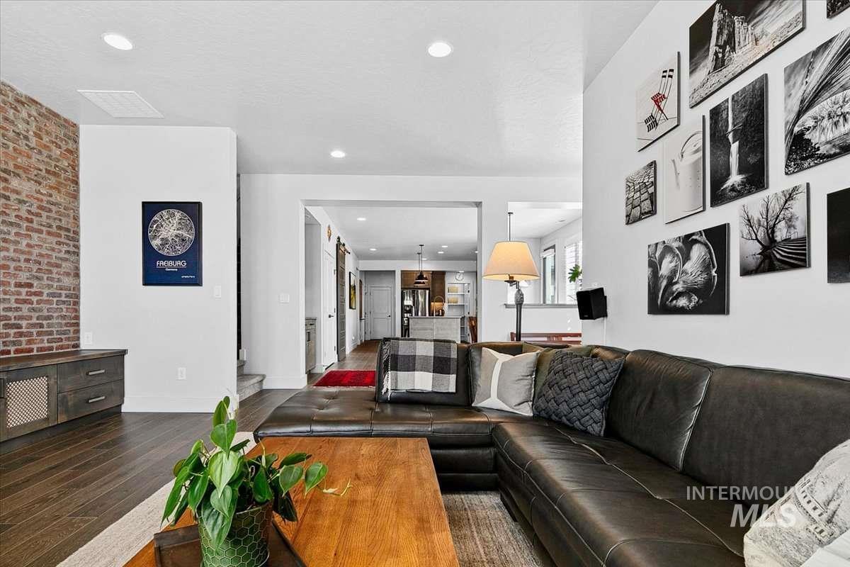 Living area featuring hardwood / wood-style floors and recessed lighting