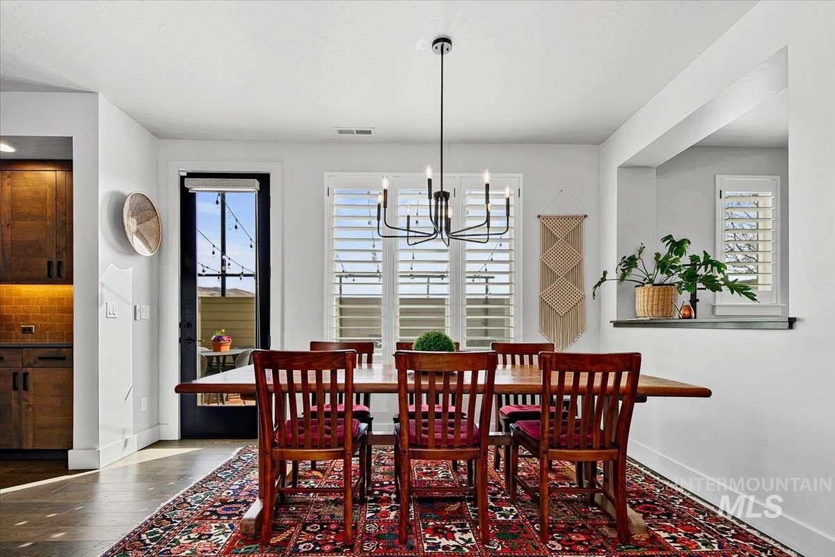 Dining room featuring a chandelier and dark wood-type flooring