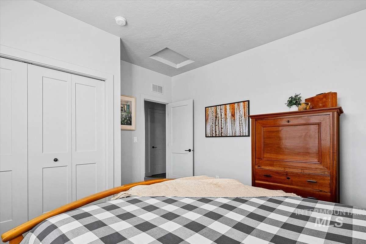 Bedroom with a closet and a textured ceiling