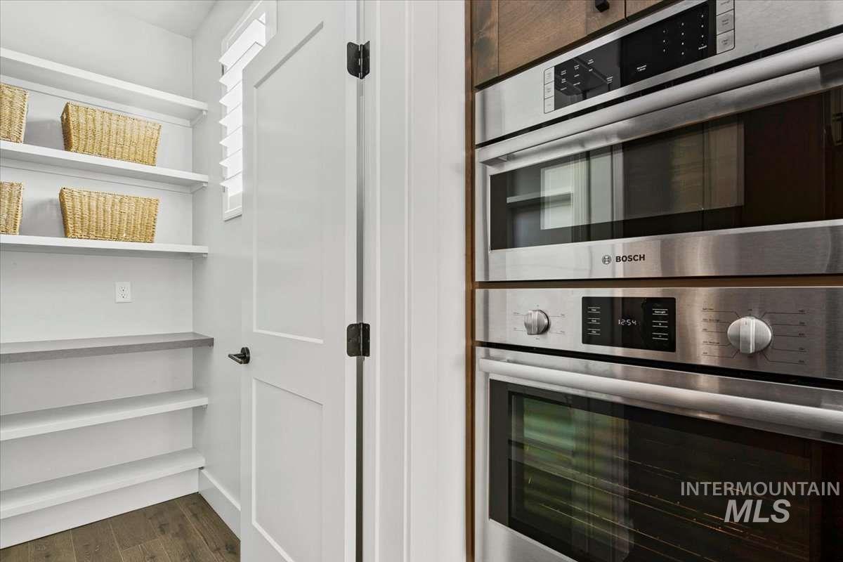 Kitchen with double oven and dark wood finished floors