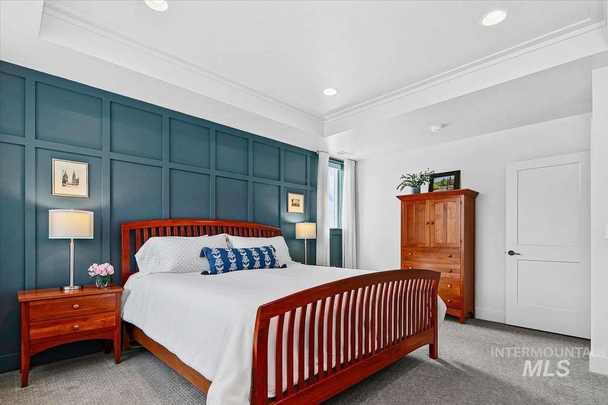 Carpeted bedroom with a decorative wall
