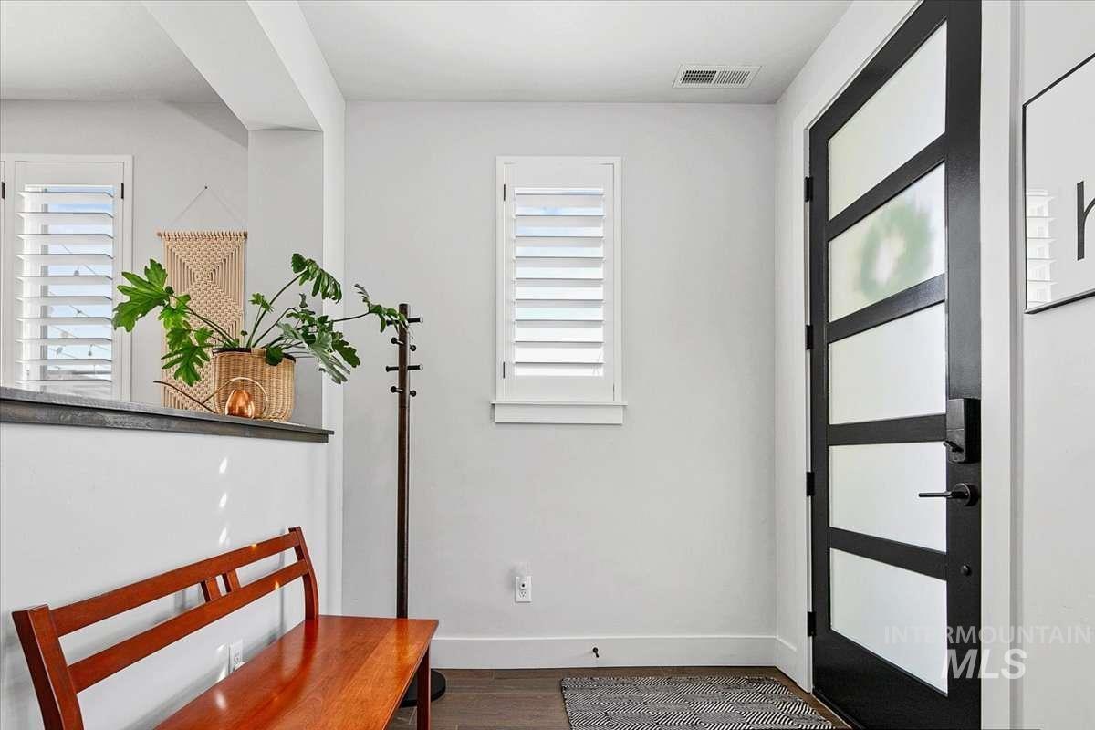 Foyer with wood finished floors and healthy amount of natural light