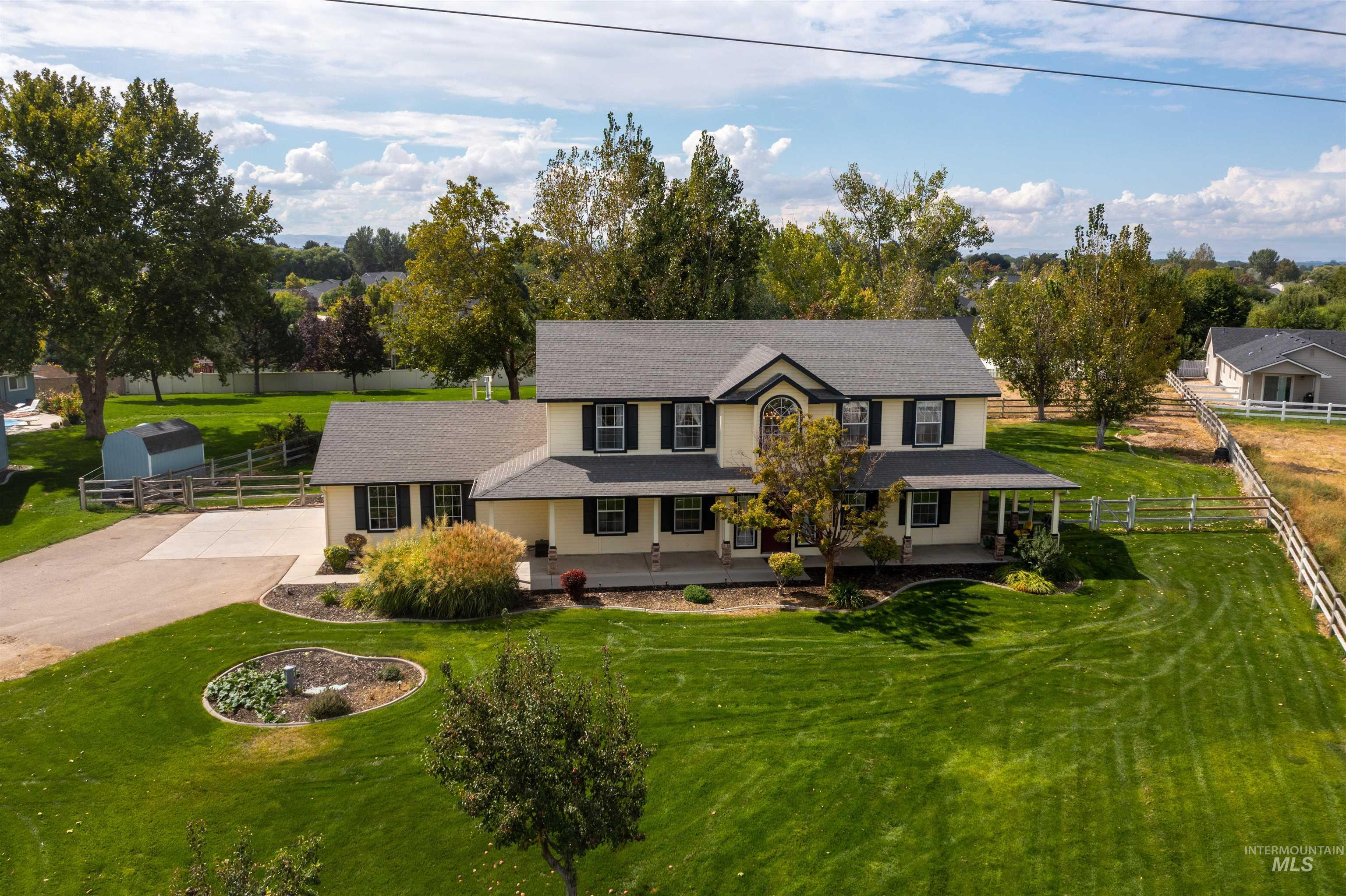 View of front of property with covered porch, concrete driveway, and roof with shingles