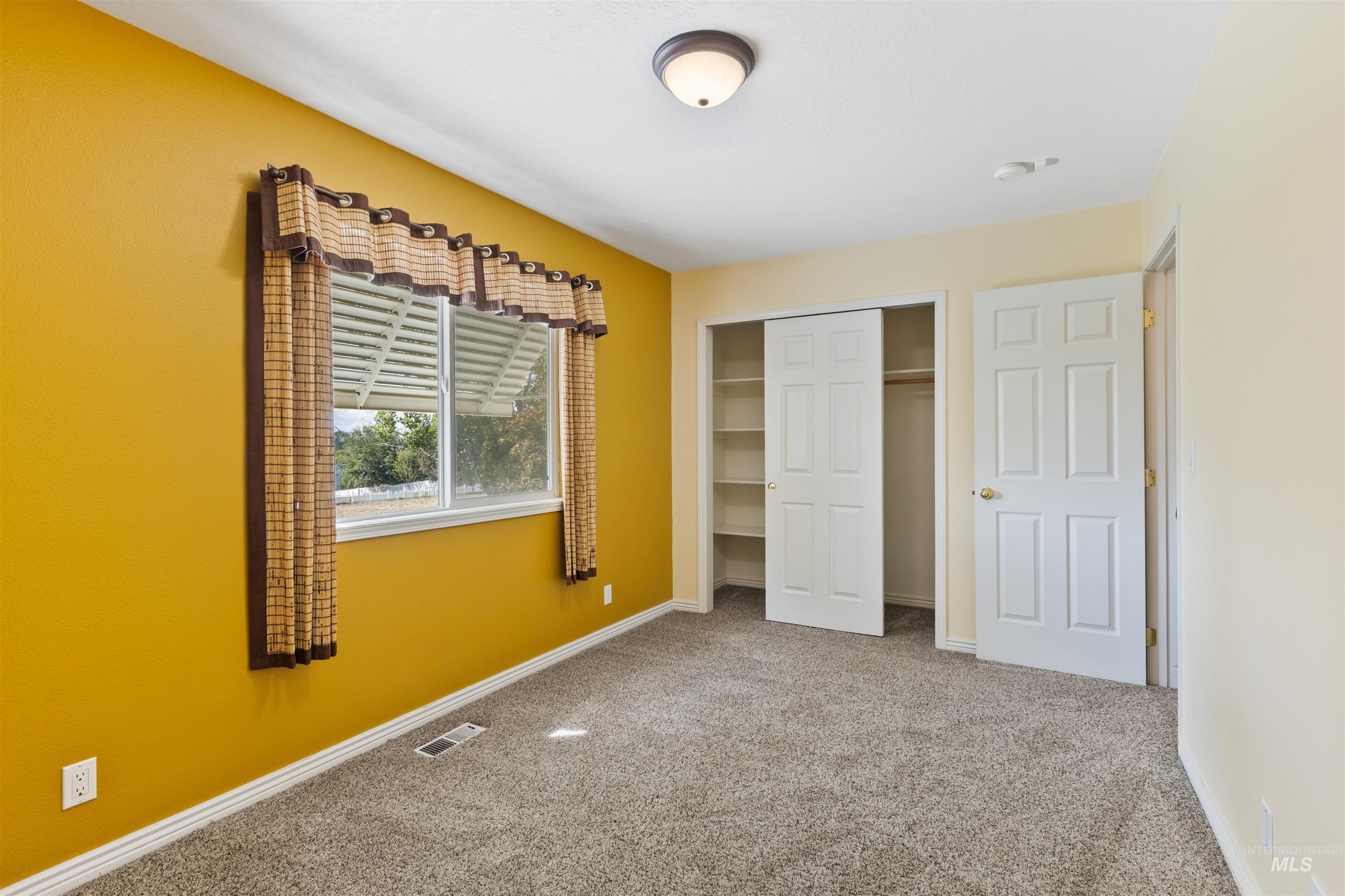 bedroom with carpet flooring and a closet