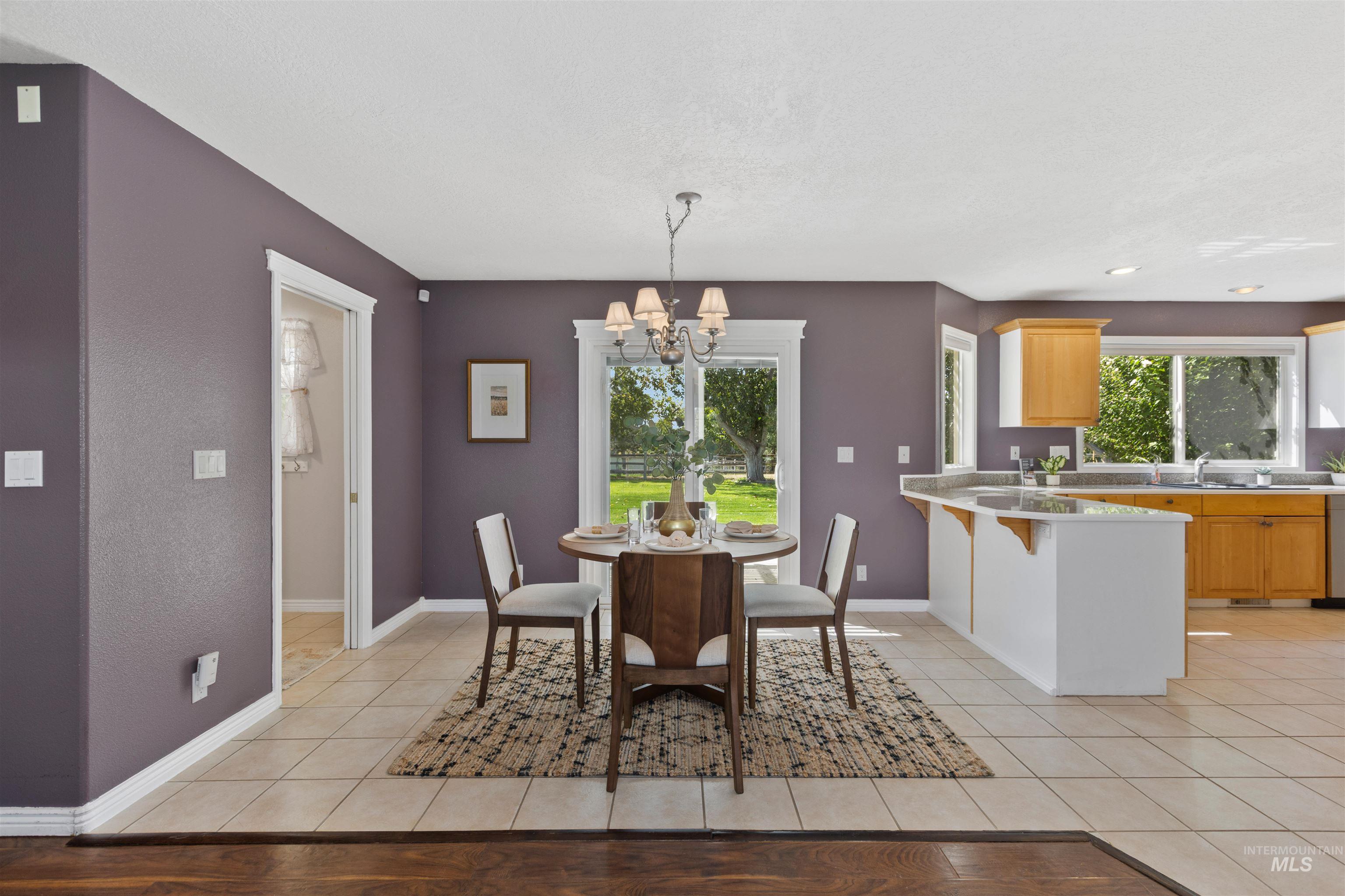 Dining room featuring light tile patterned floors and a chandelier