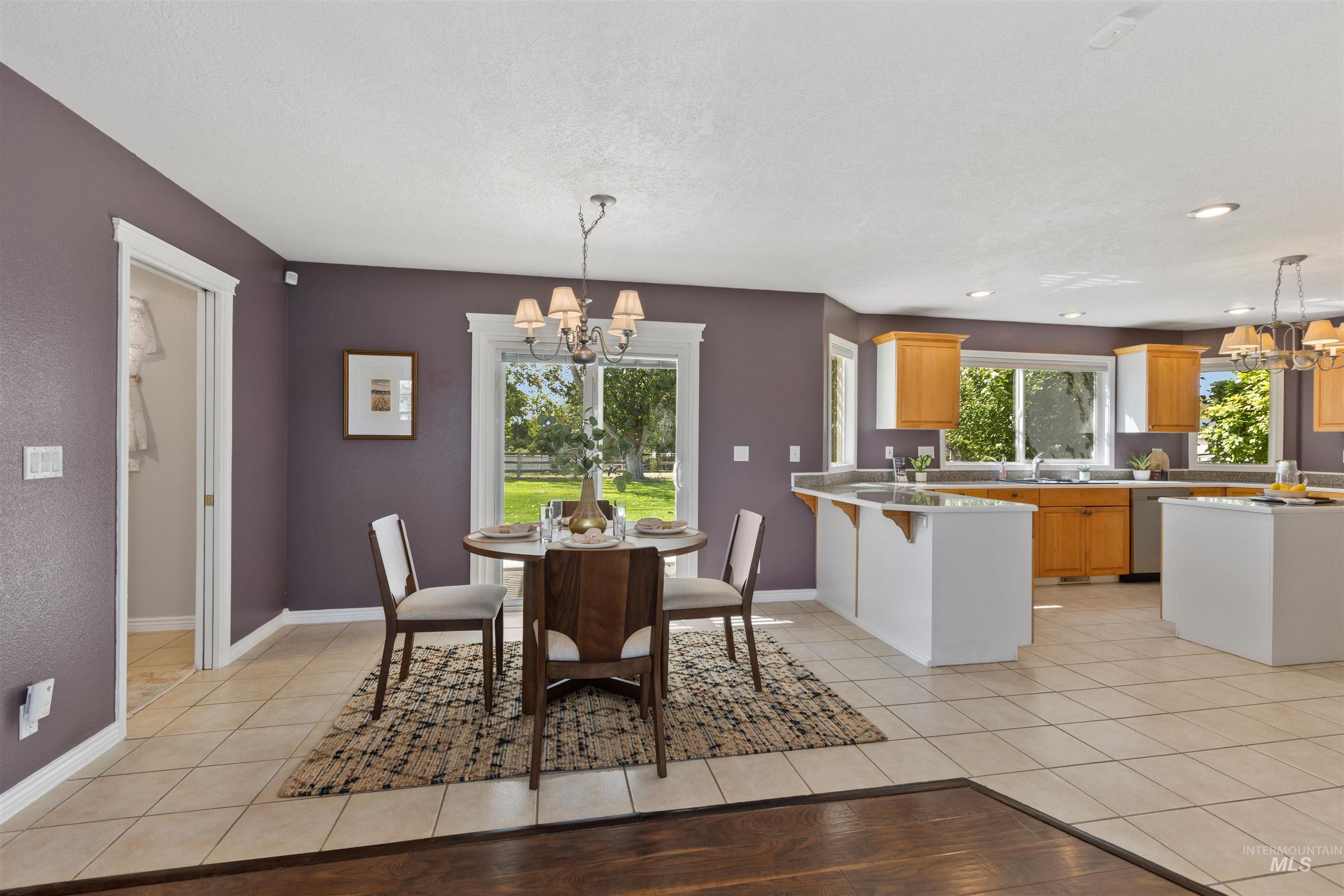 Dining room featuring a chandelier and light tile patterned floors