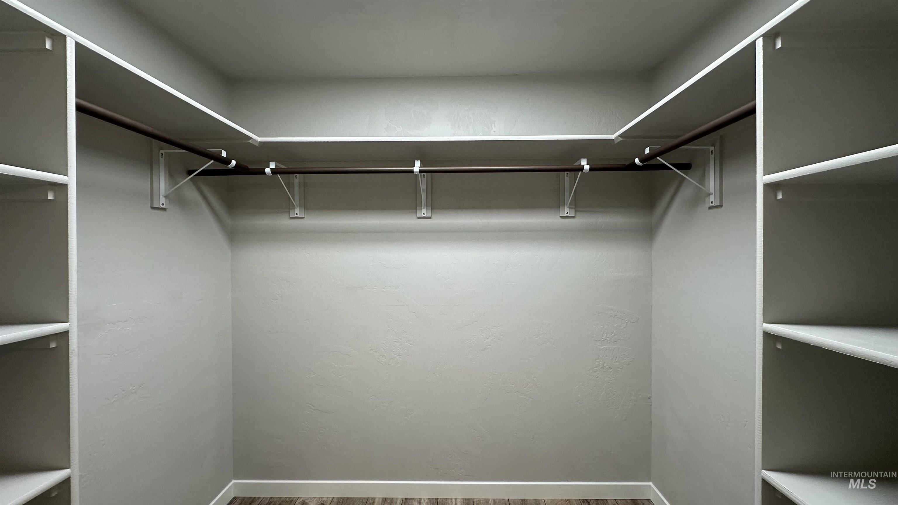 Walk in closet featuring wood finished floors