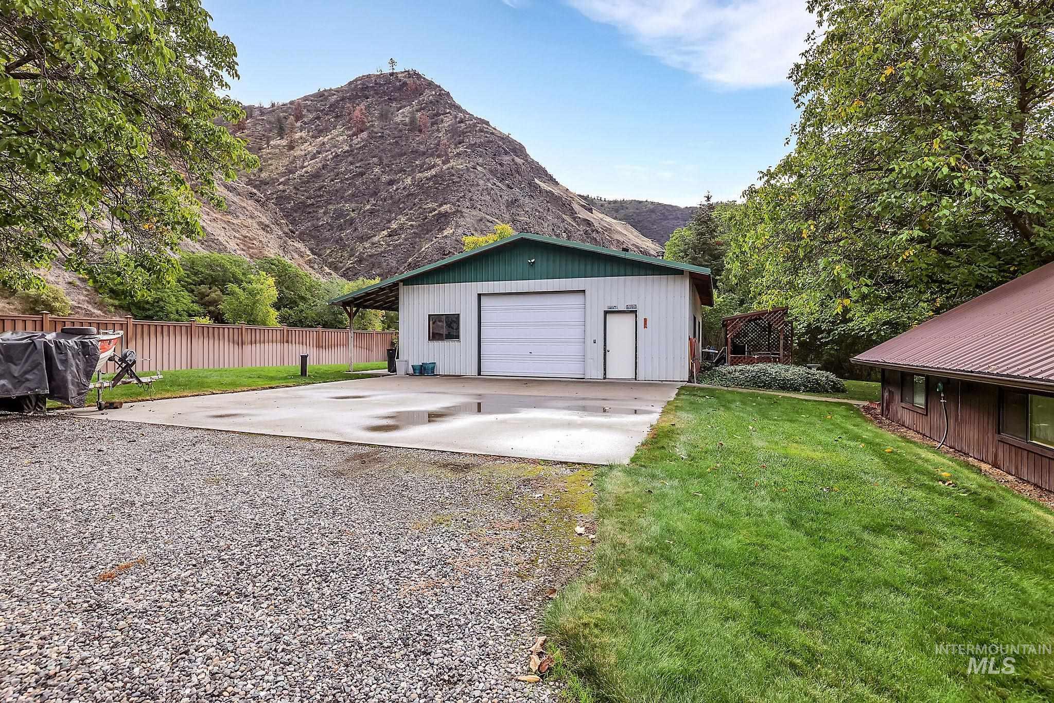 Detached garage featuring driveway and a mountain view