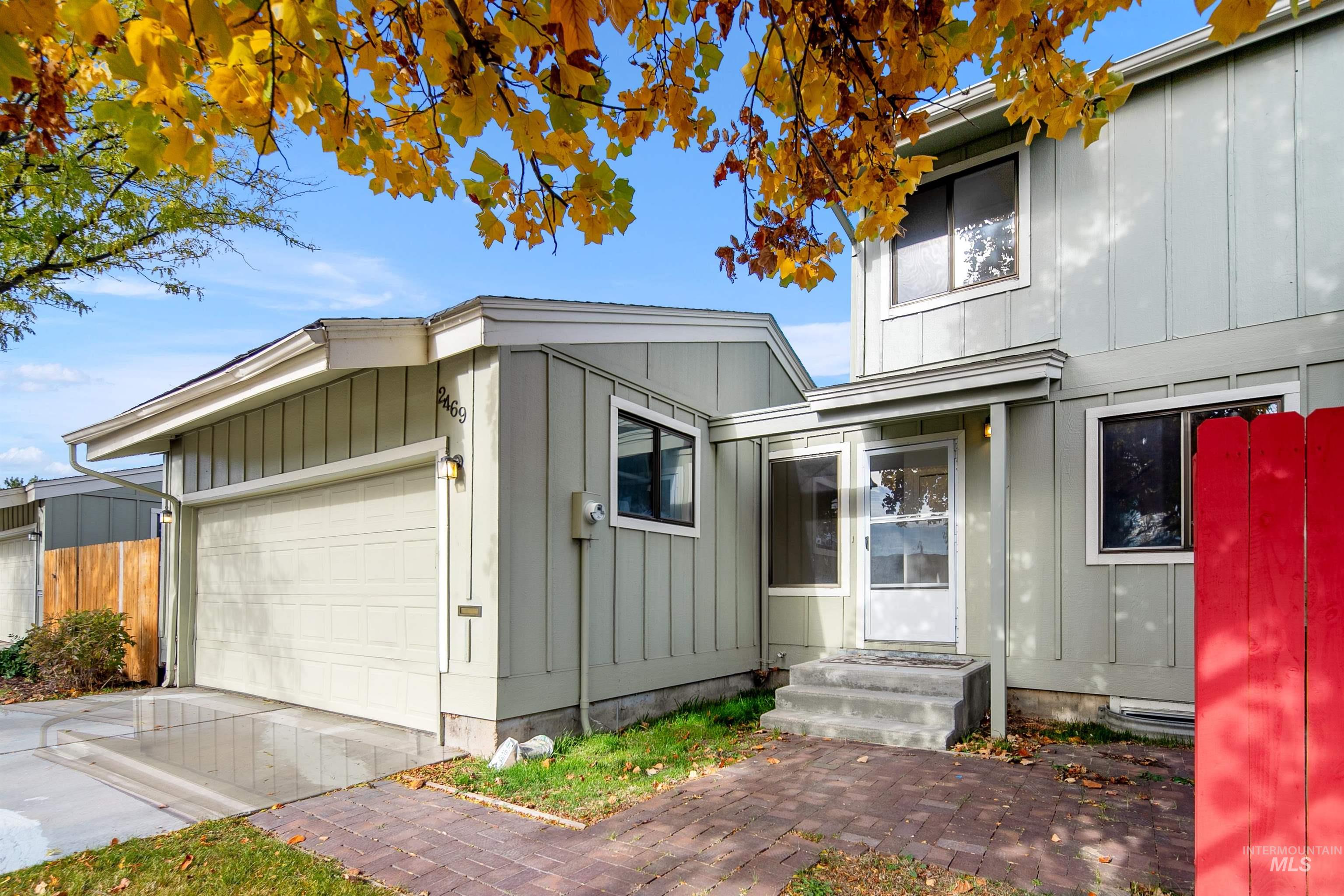 View of front of home featuring board and batten siding, an attached garage, and driveway