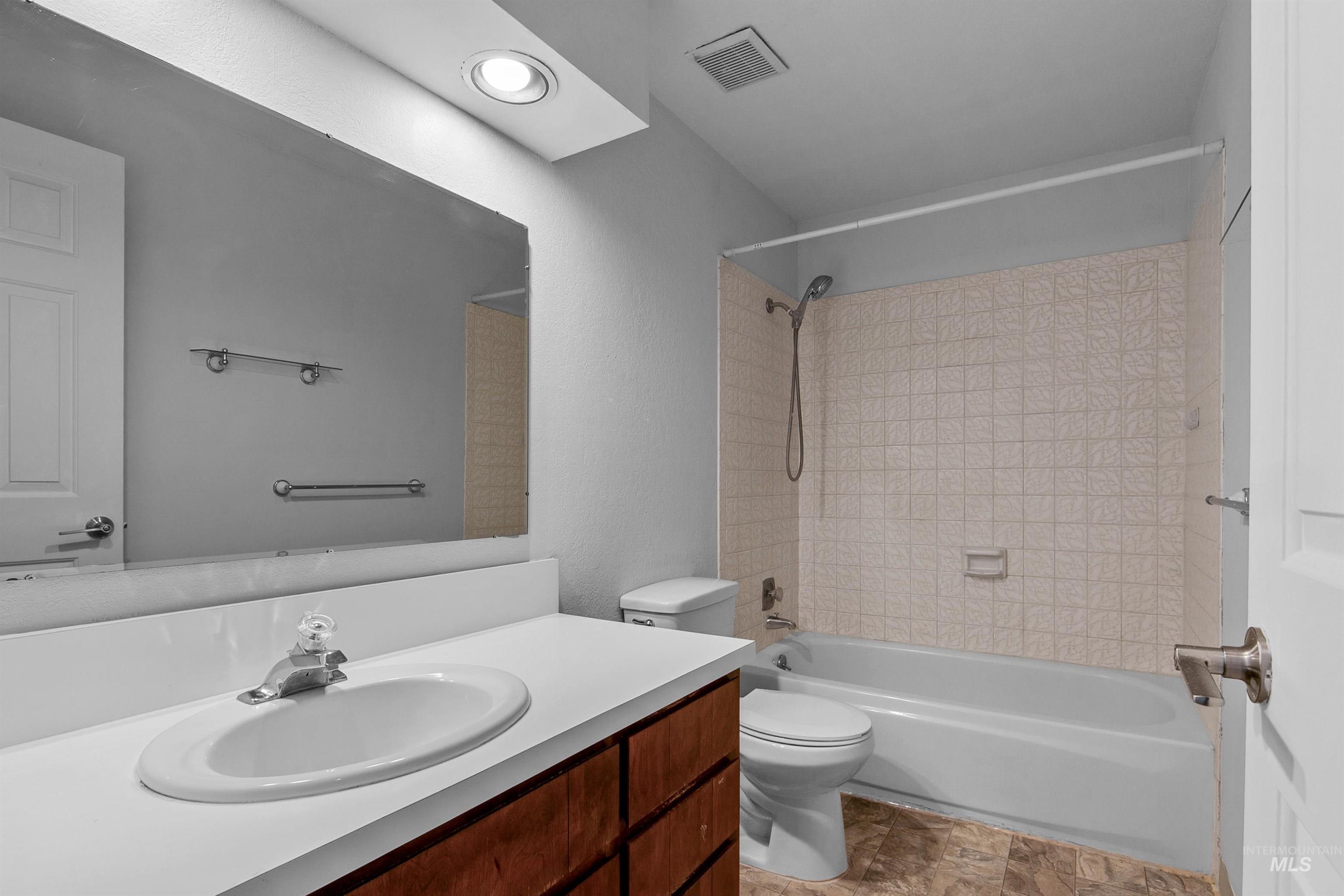 Bathroom featuring shower / bathtub combination and vanity