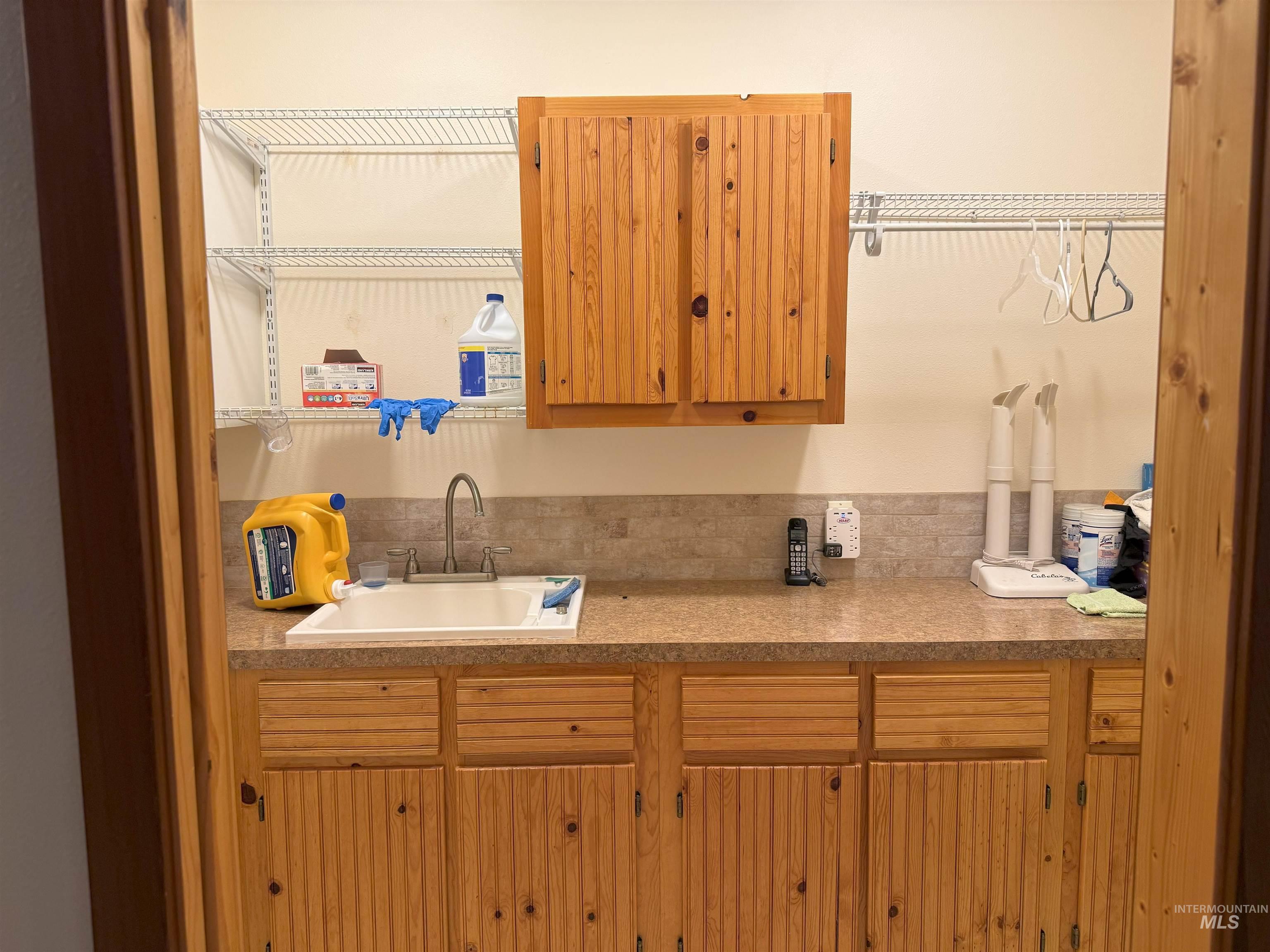 Kitchen with a sink and light countertops