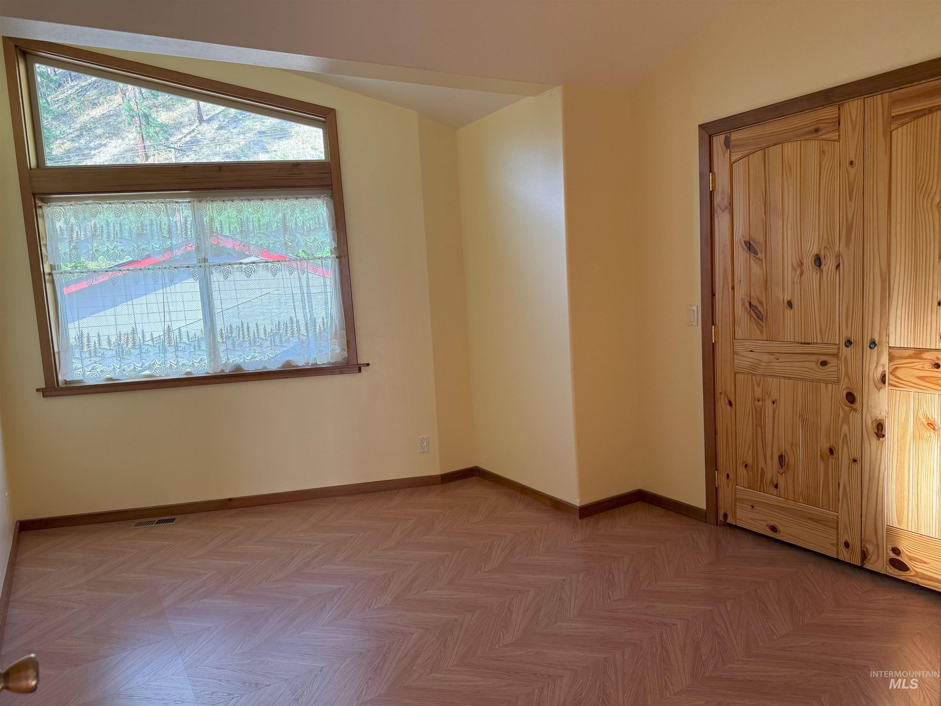 Unfurnished room with baseboards