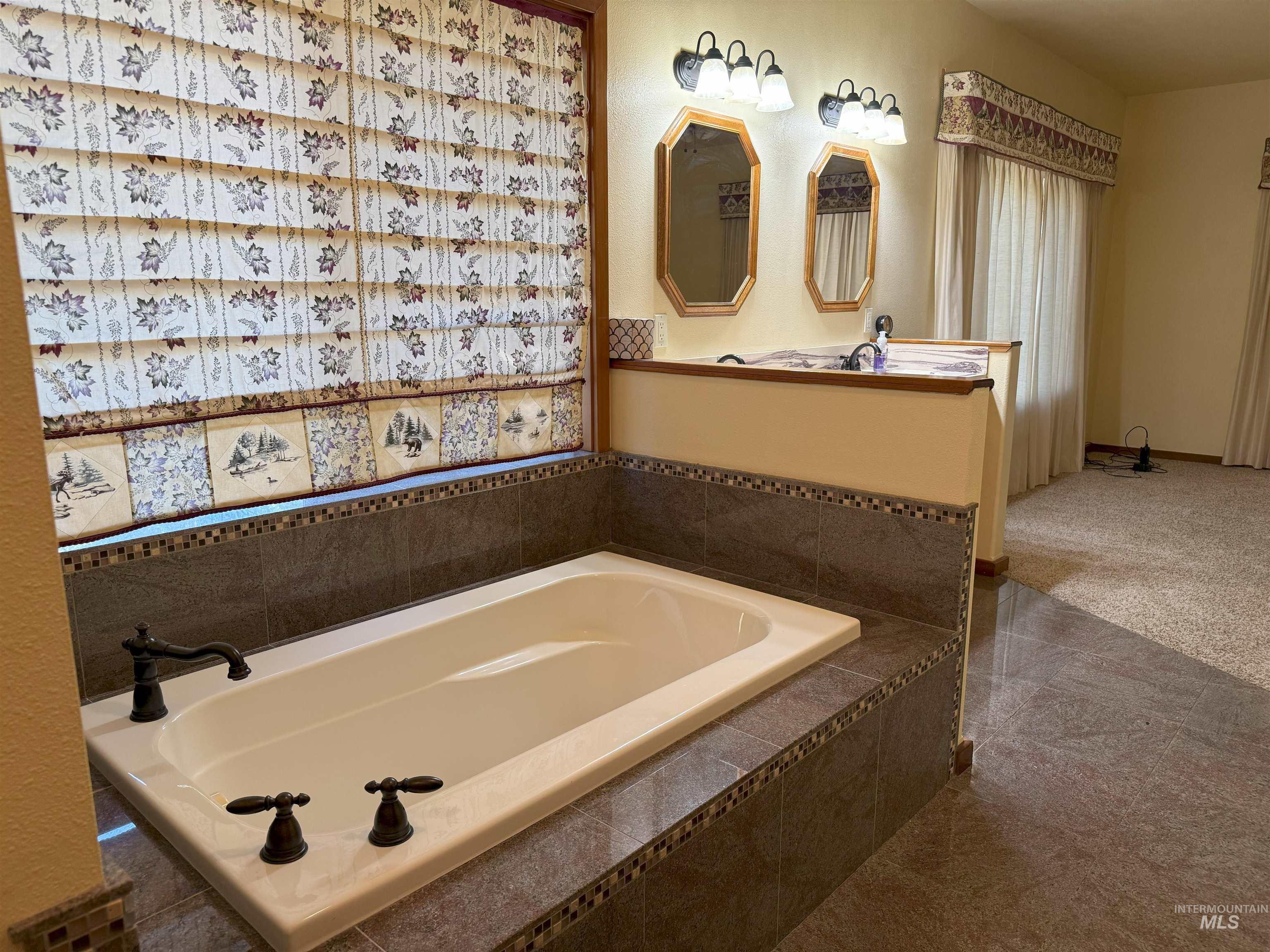Bathroom featuring a bath and vanity