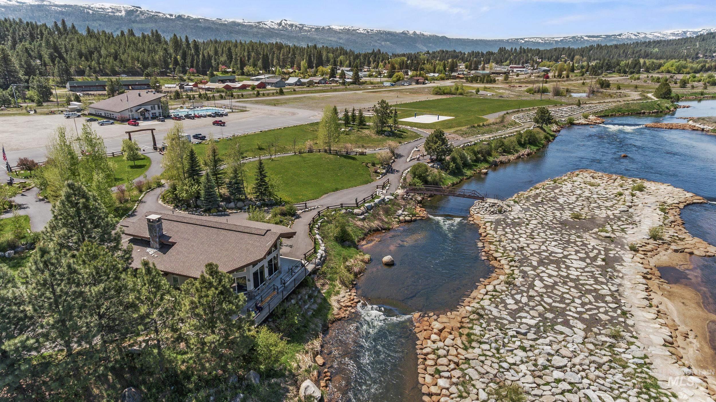 Bird's eye view of a heavily wooded area and a water and mountain view