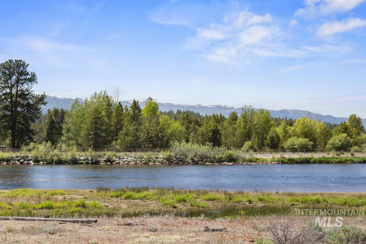 Water view with a heavily wooded area and a mountain backdrop