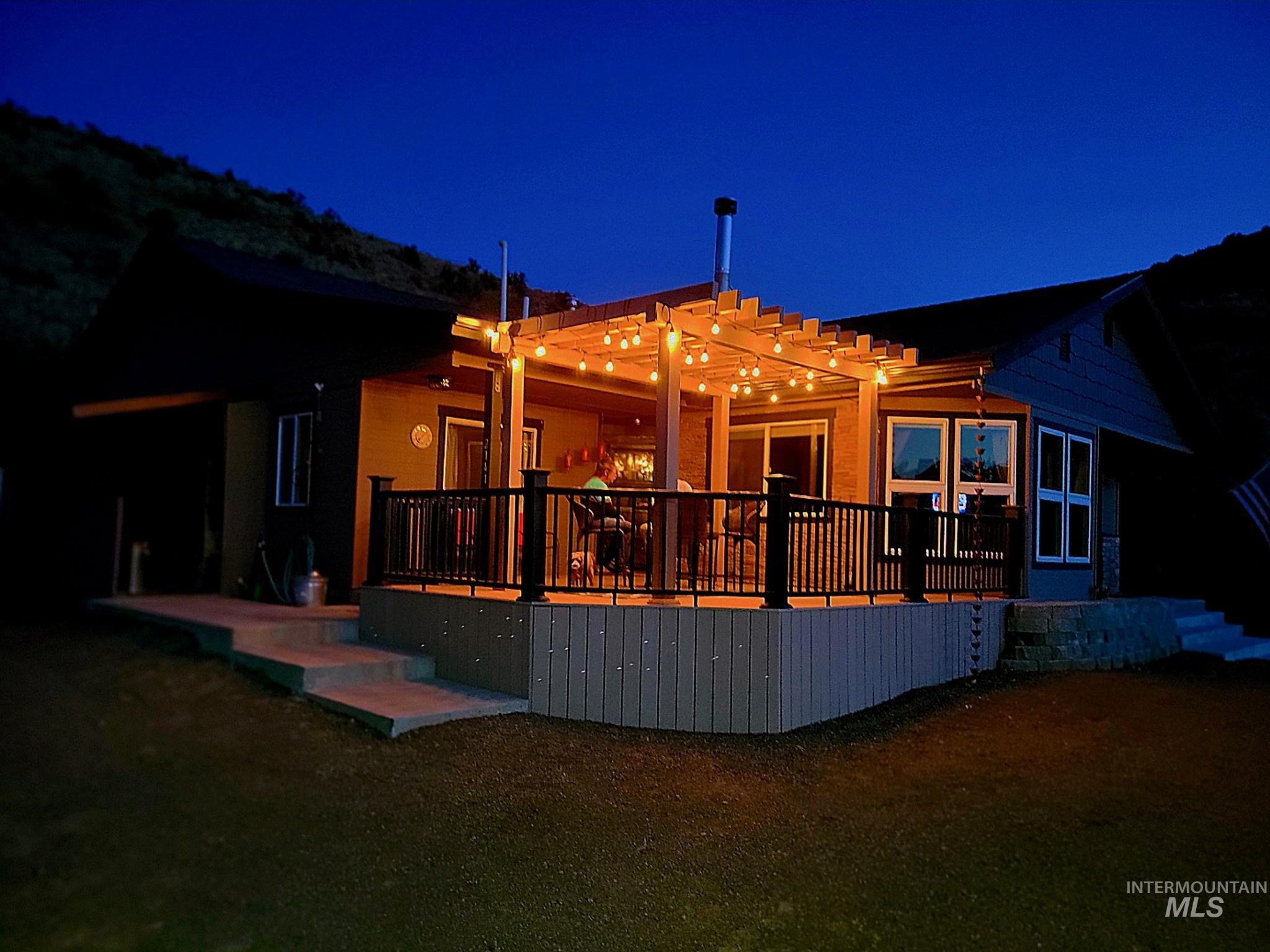 House at twilight featuring a wooden deck great for hosting get togethers or just relaxing