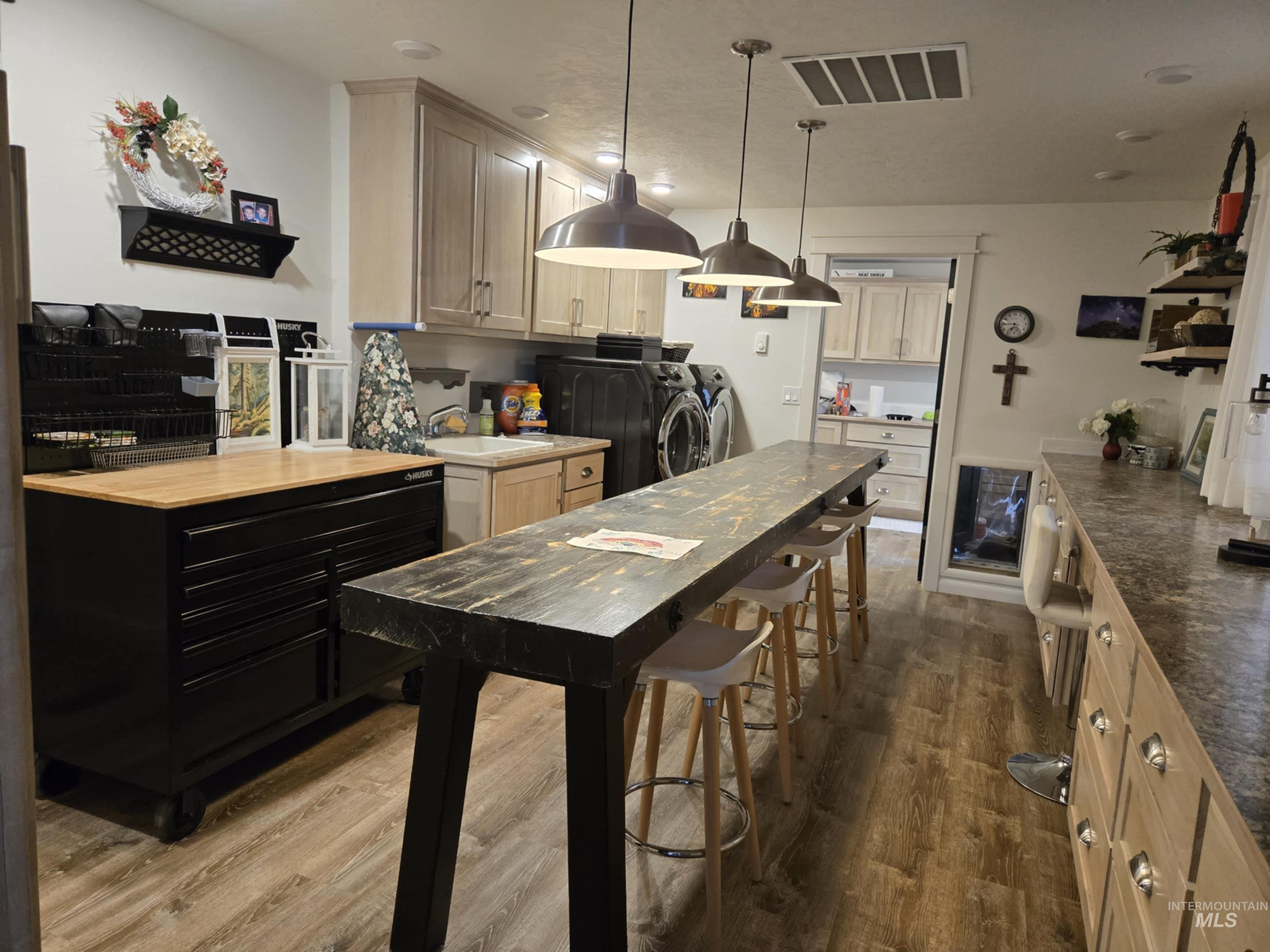 The laundry/craft room is as functional as it is versatile, with a utility sink and storage galore to keep everything organized