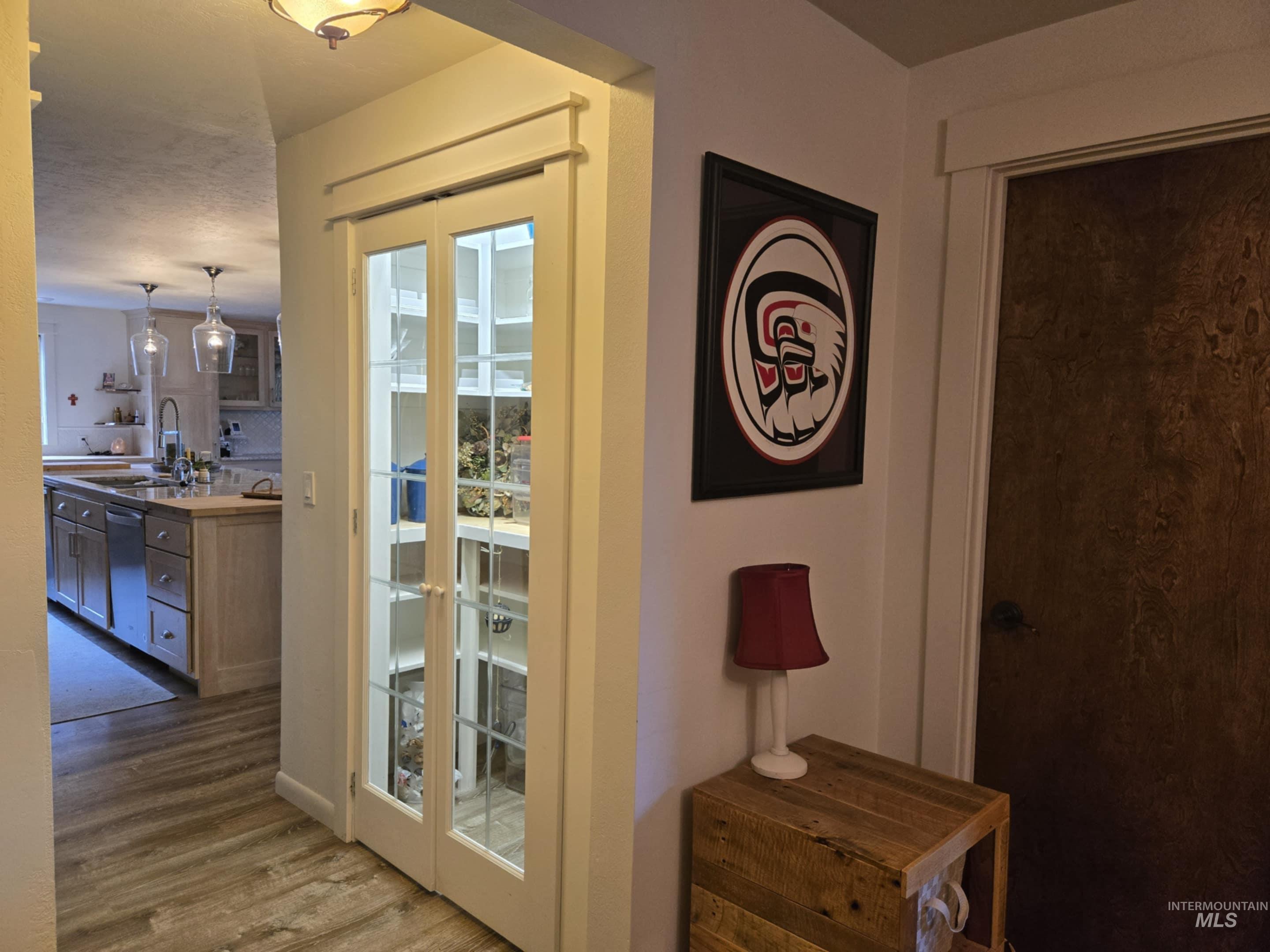 A lighted pantry with glass French doors adds both style and function, keeping everything organized and beautifully displayed