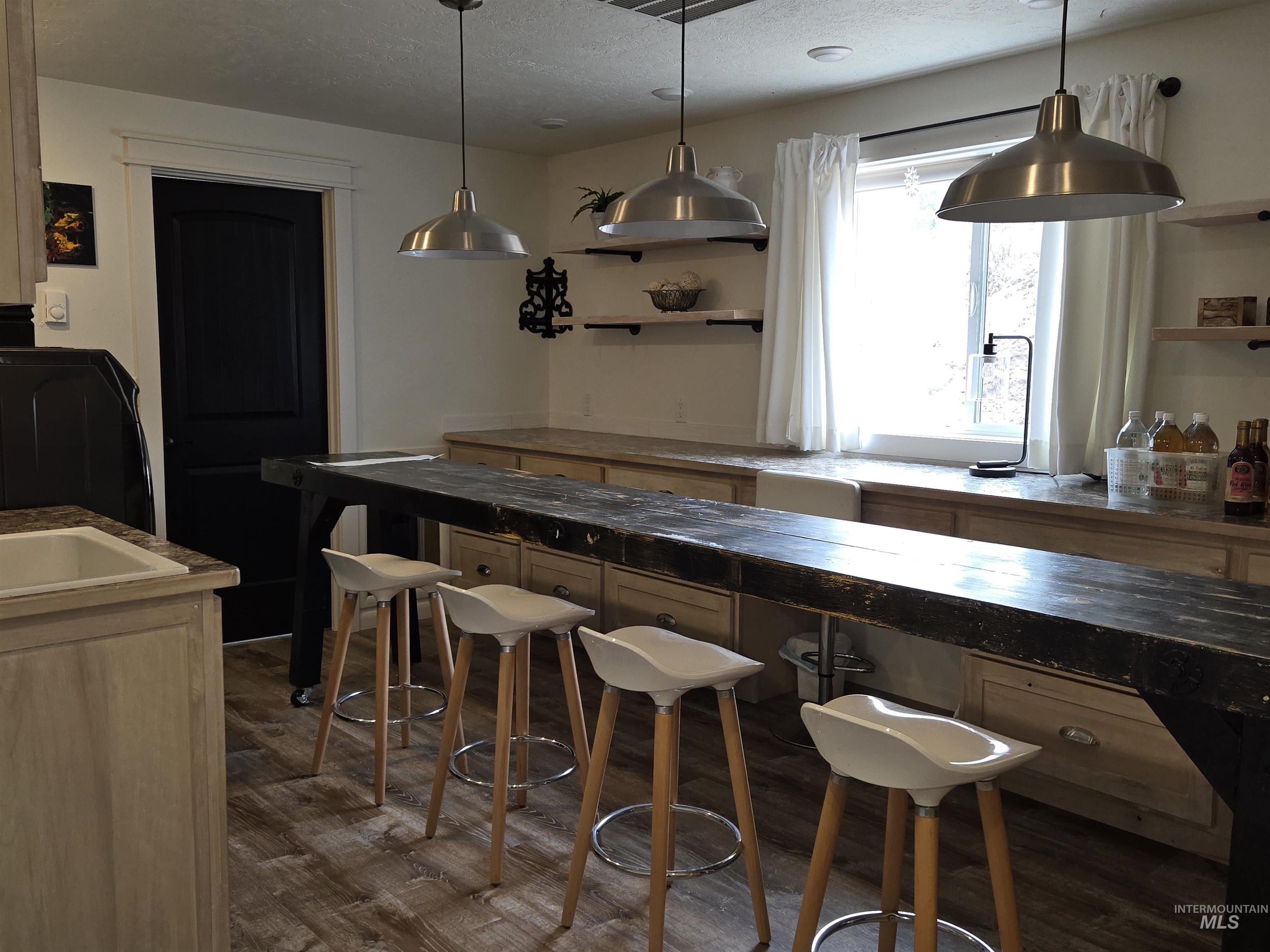 Storage galore and a utility sink make the laundry/craft room both practical and inspiring for daily chores and creative moments