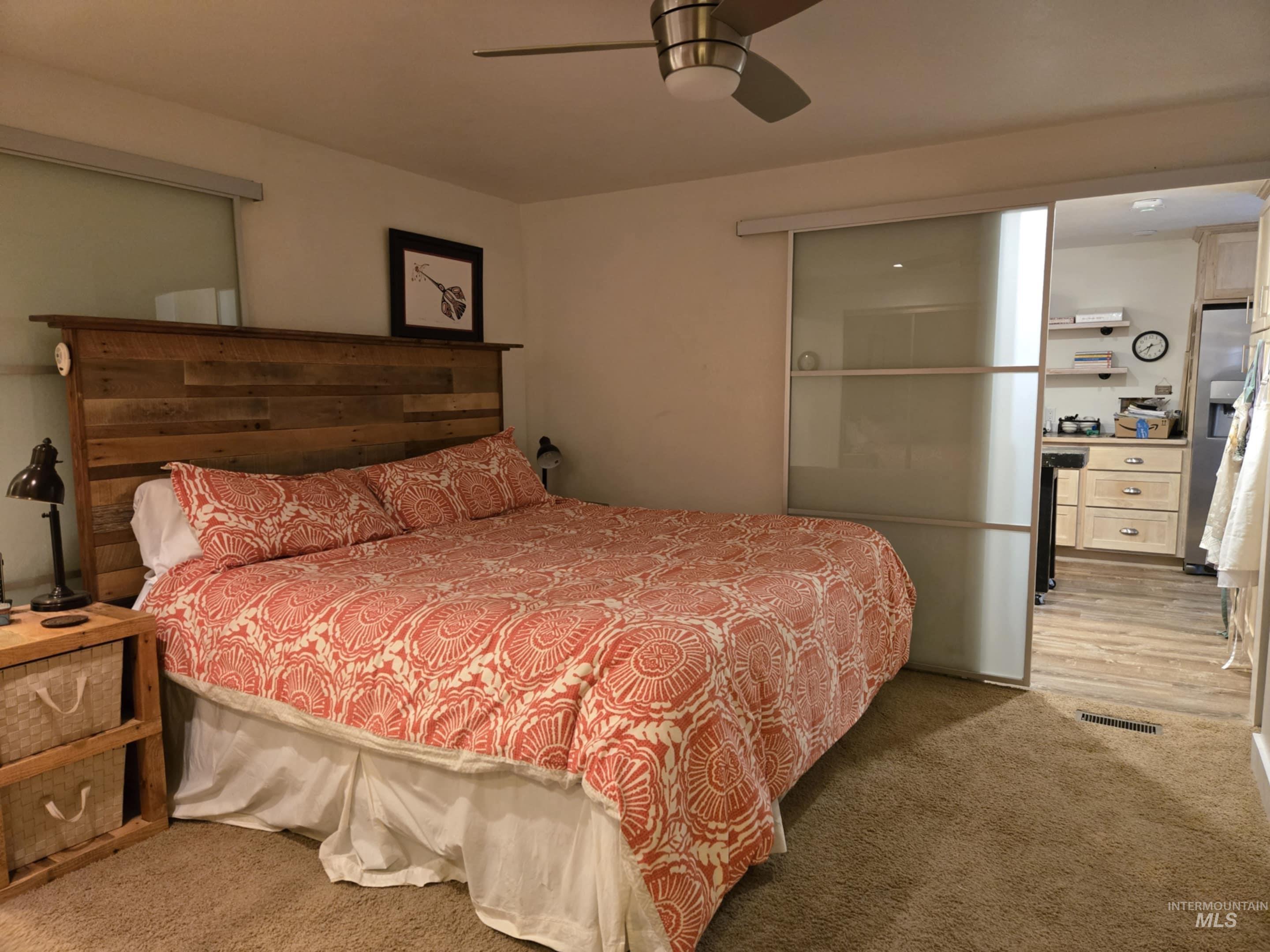The primary bedroom feels both modern and inviting, featuring oversized frosted glass barn-style sliding doors that provide privacy with a touch of style