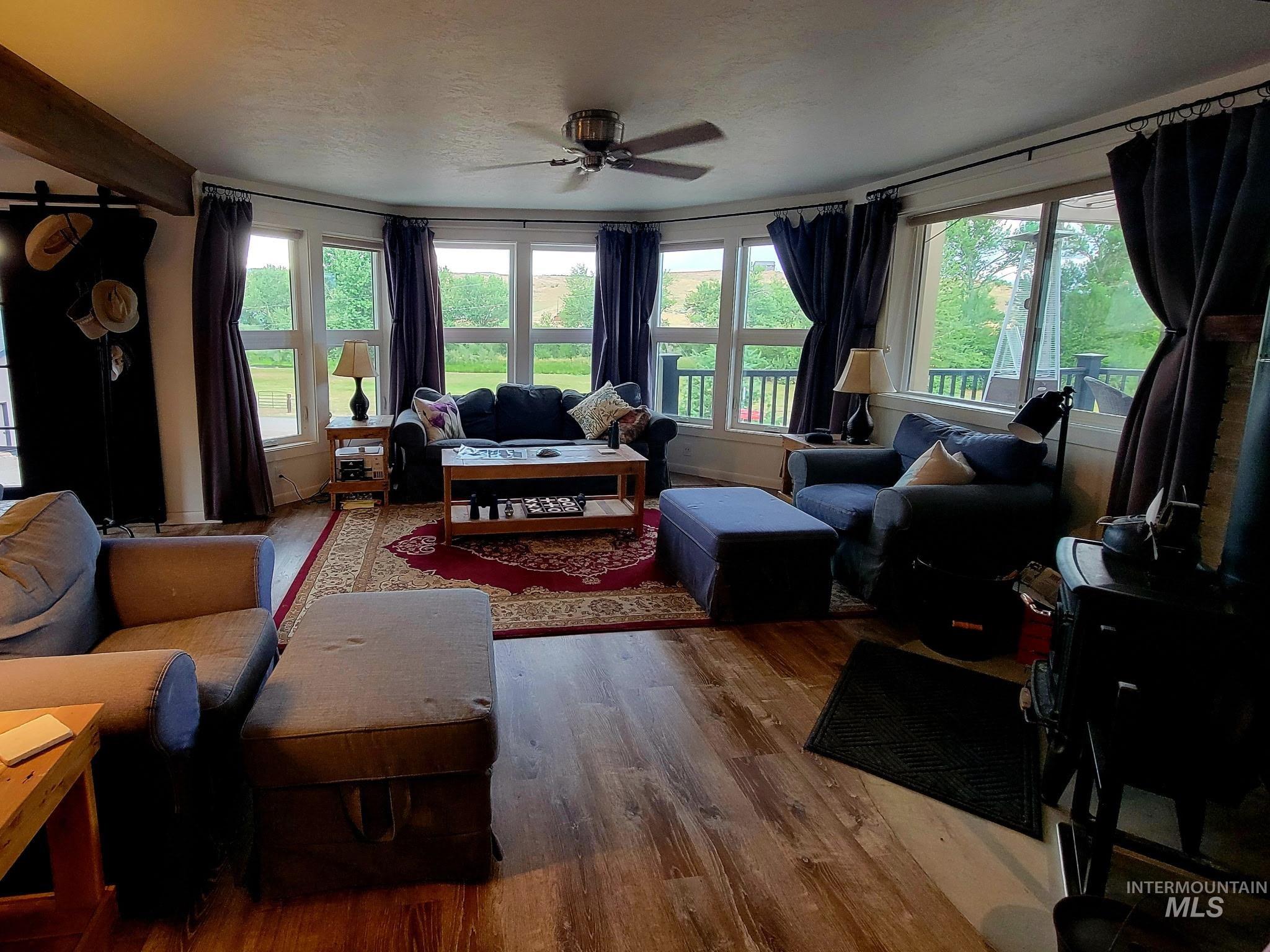 Living area featuring plenty of natural light. Most furnishings included