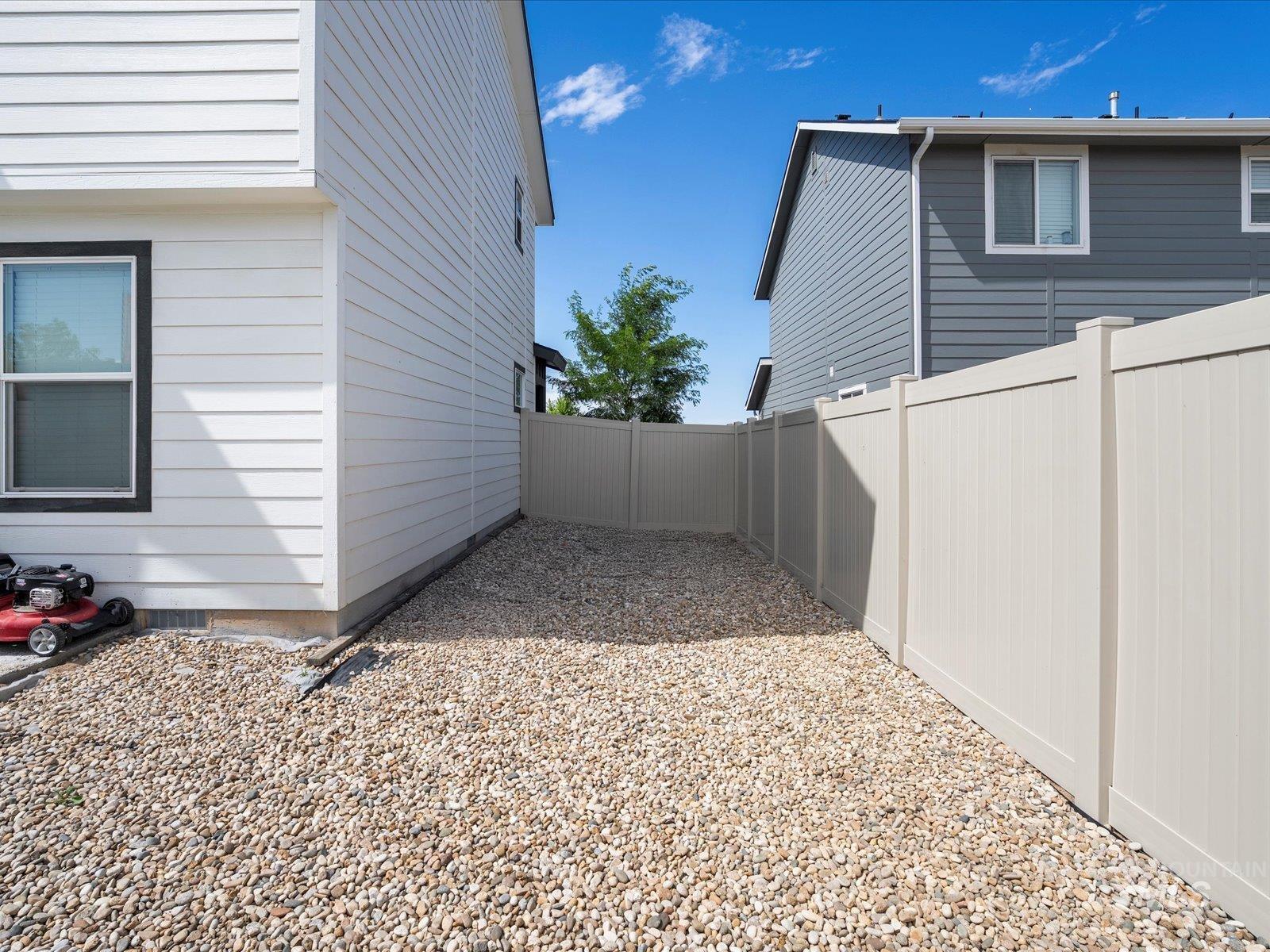 View of side of home featuring a fenced backyard