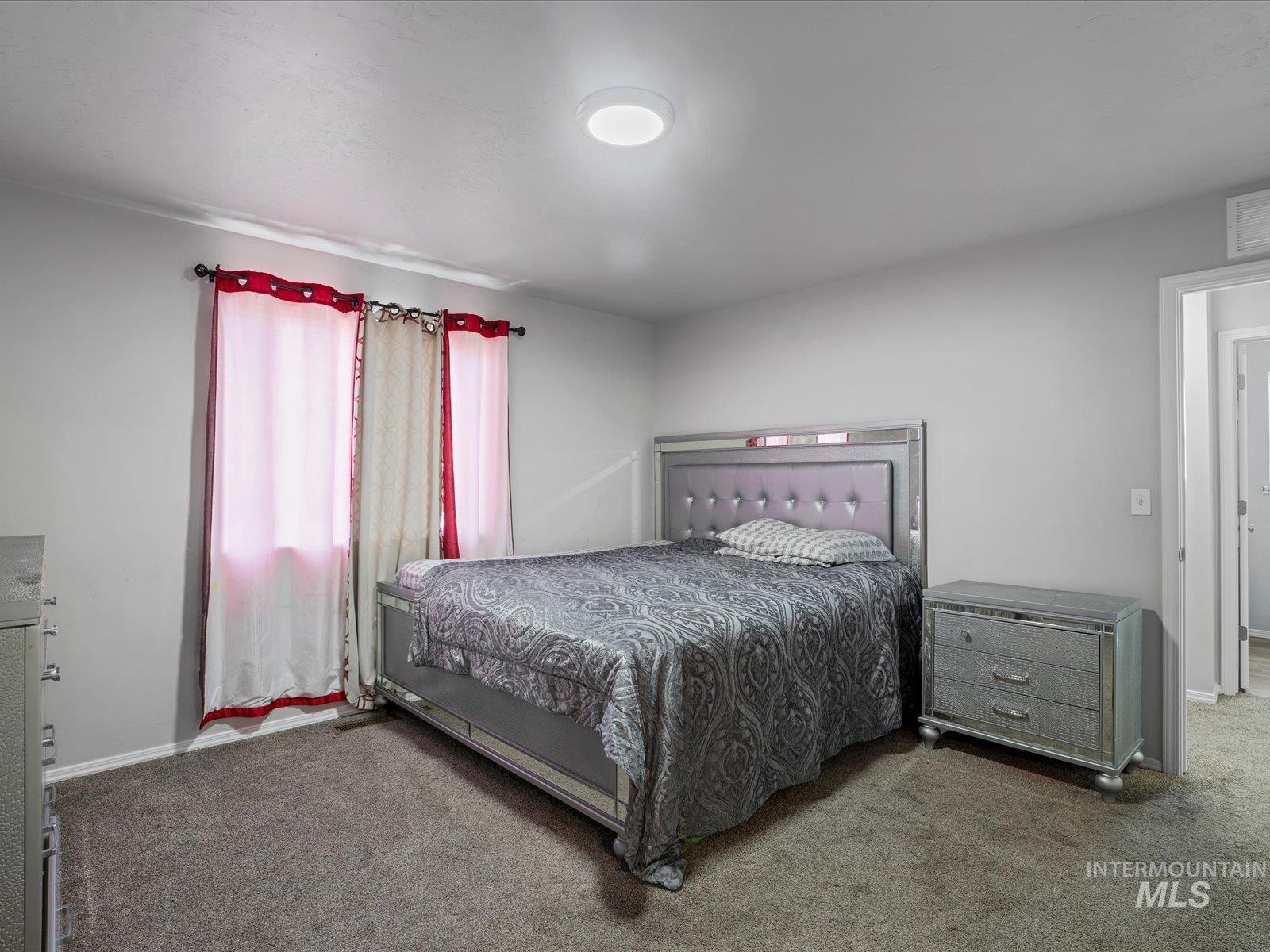 Bedroom with carpet floors and baseboards