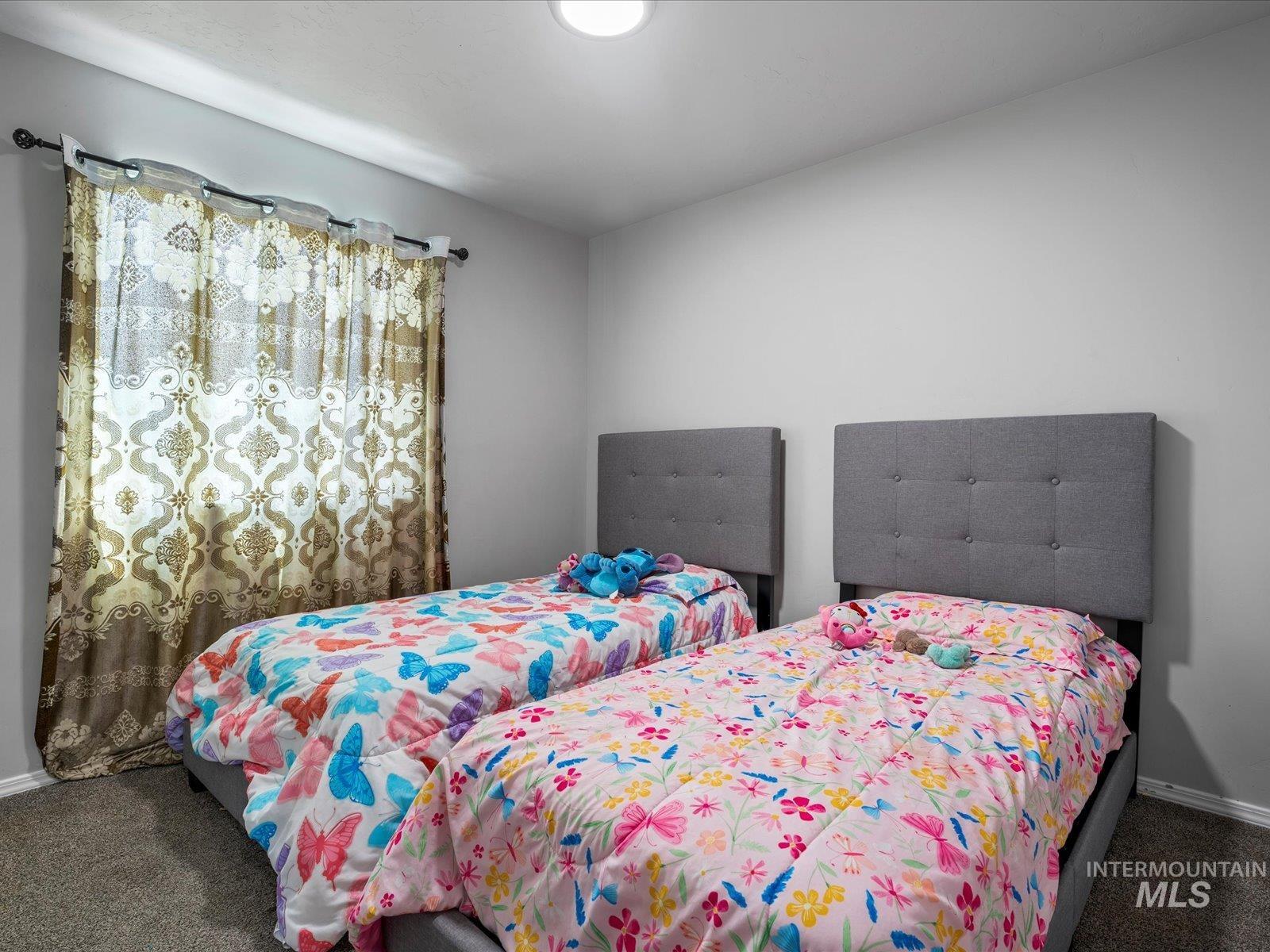 Bedroom with carpet and baseboards