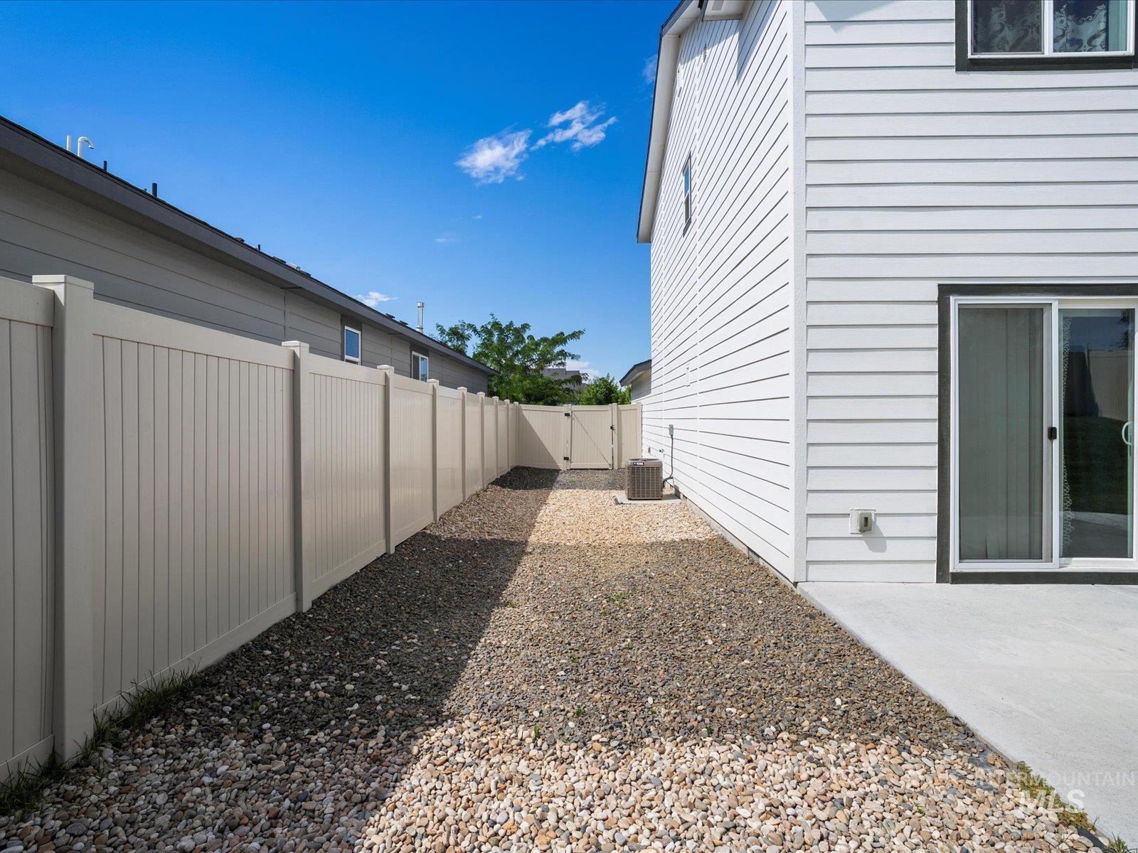View of yard with a gate and a patio