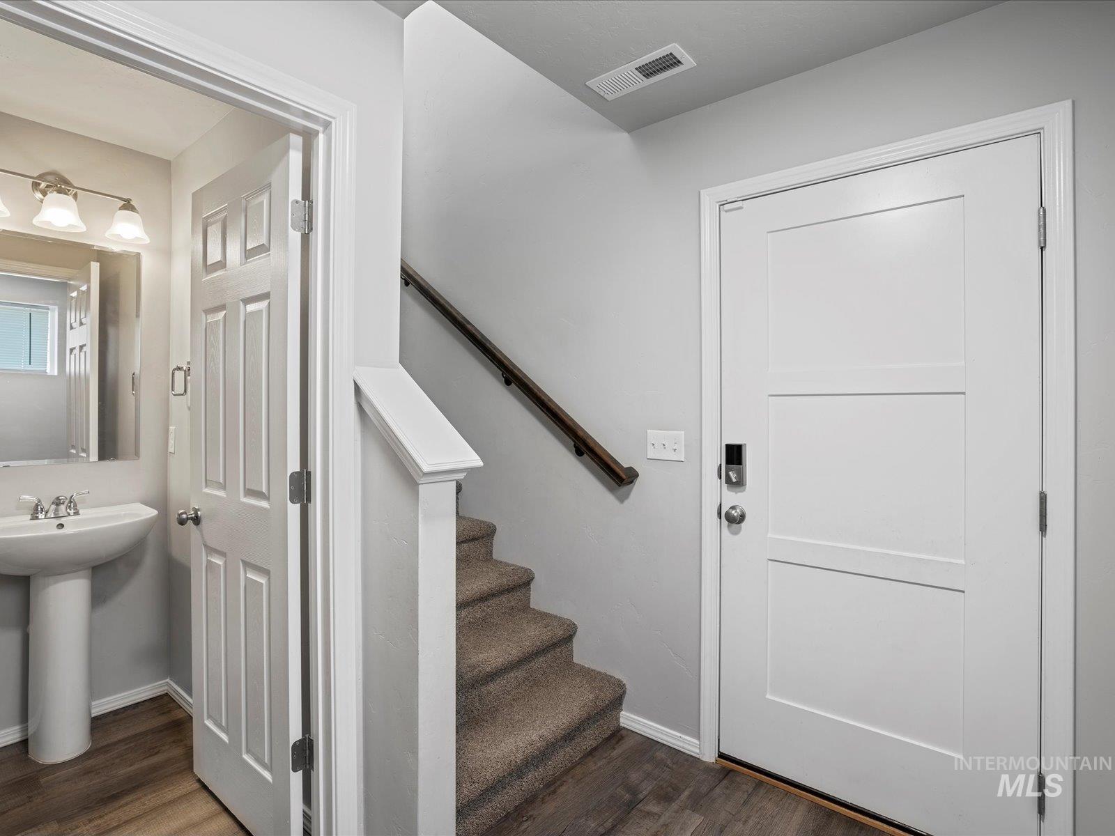 Stairs featuring wood finished floors
