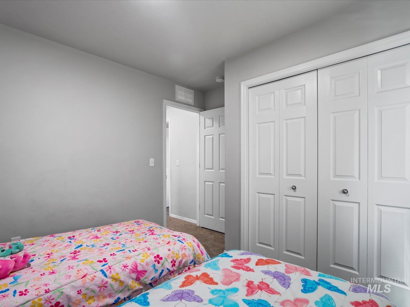 Bedroom with carpet floors and a closet