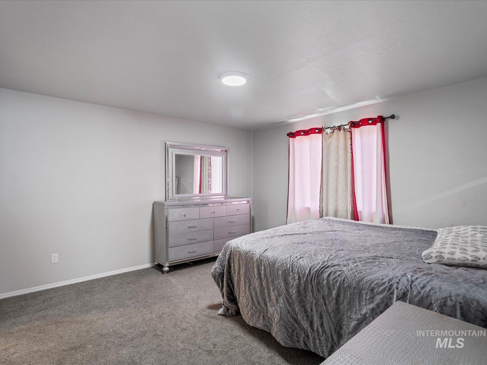 Bedroom with carpet flooring and baseboards