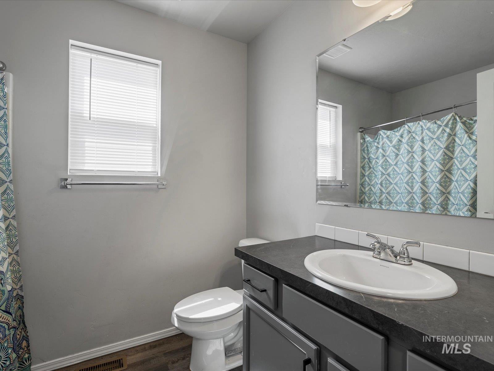 Bathroom with vanity and wood finished floors