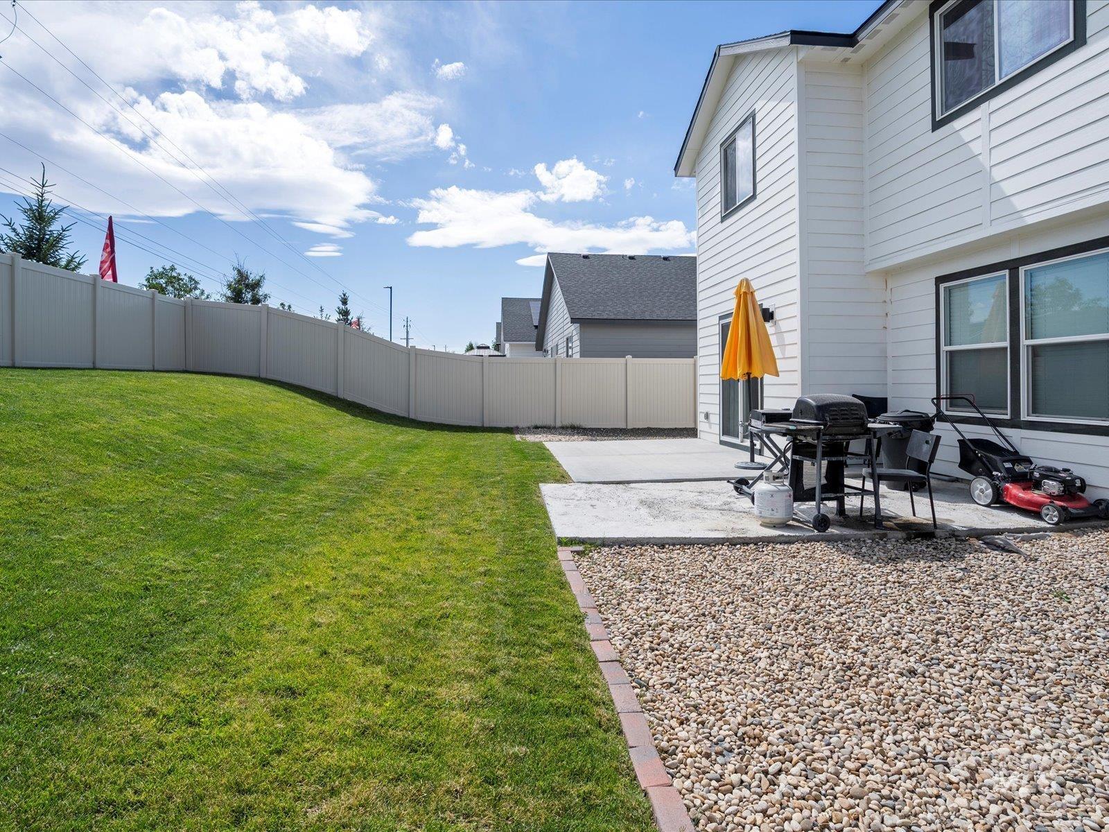Fenced backyard with a patio