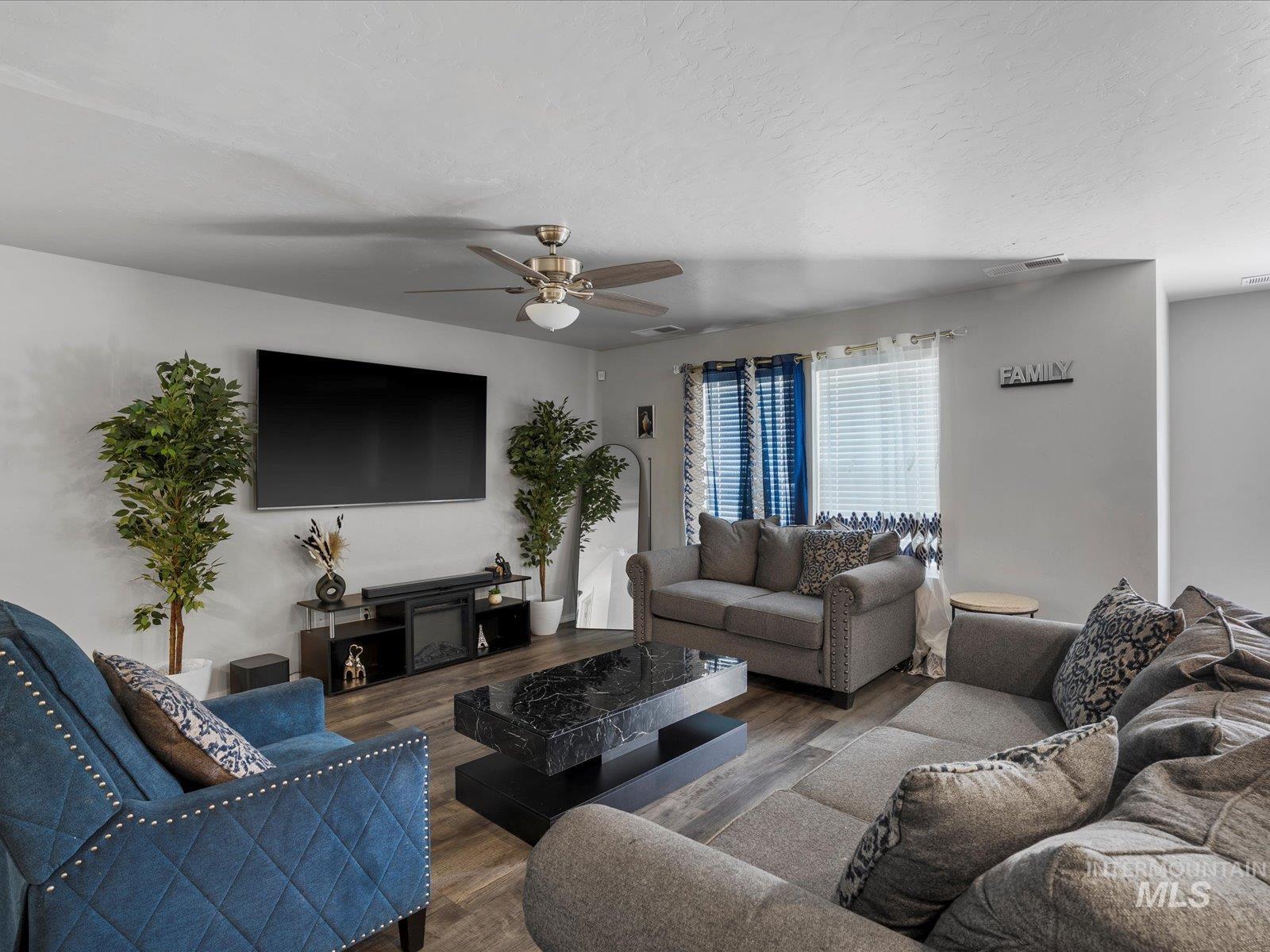 Living area featuring a ceiling fan and wood finished floors