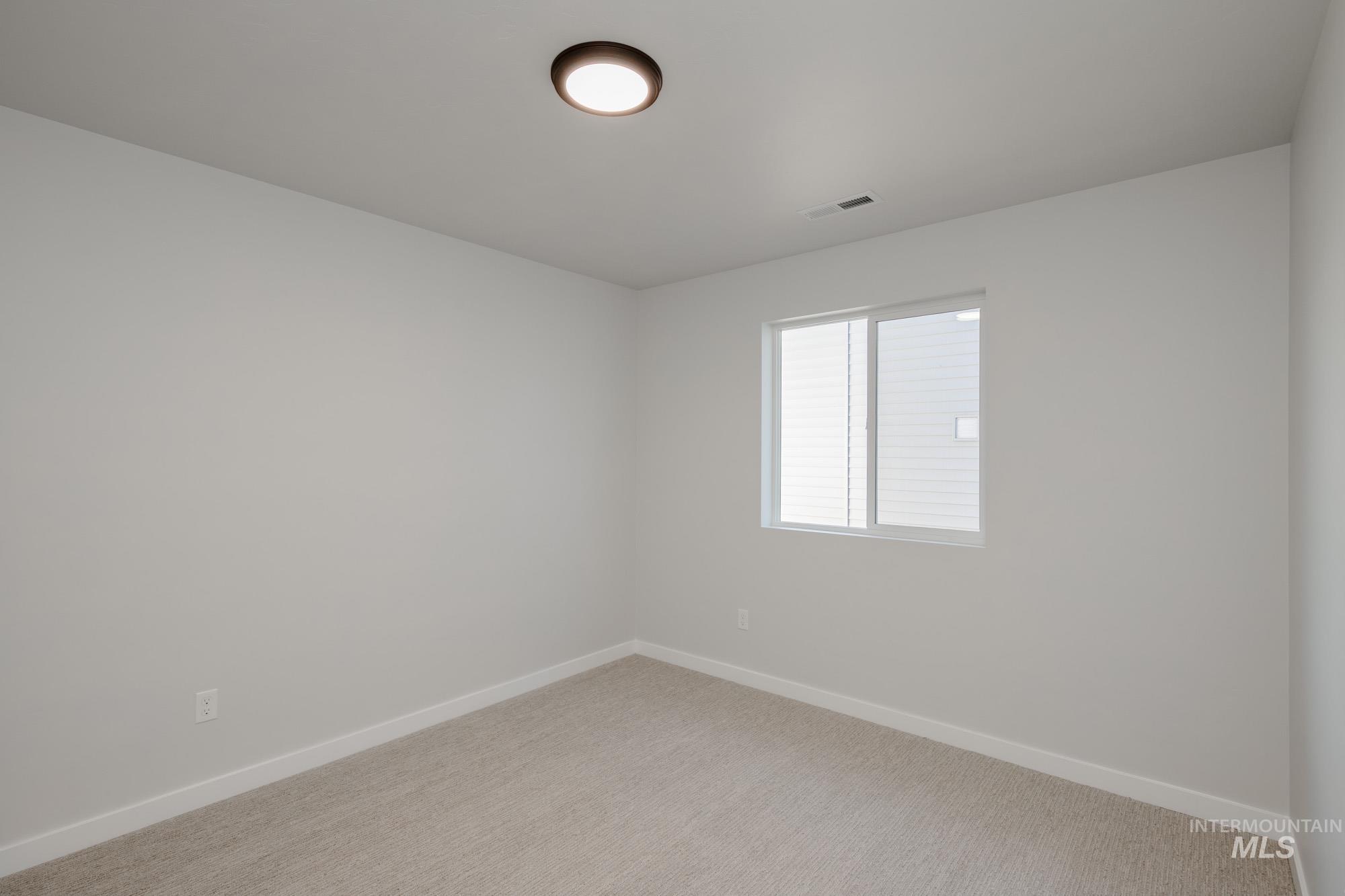 Spare room with baseboards and carpet