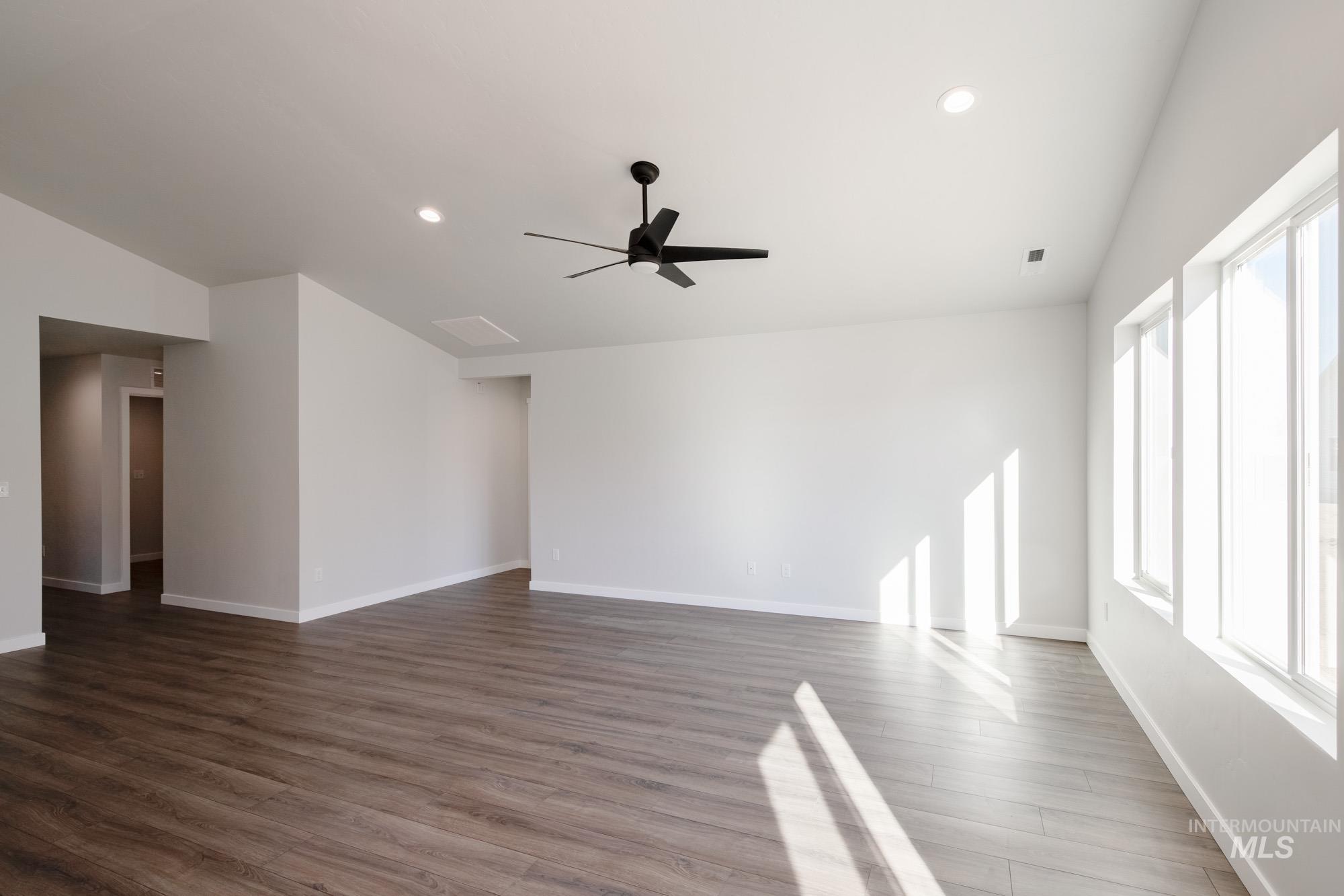 Unfurnished living room with recessed lighting, wood finished floors, and ceiling fan