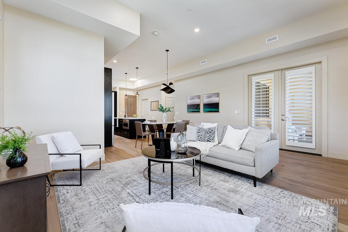 Living area featuring light wood-style floors and recessed lighting